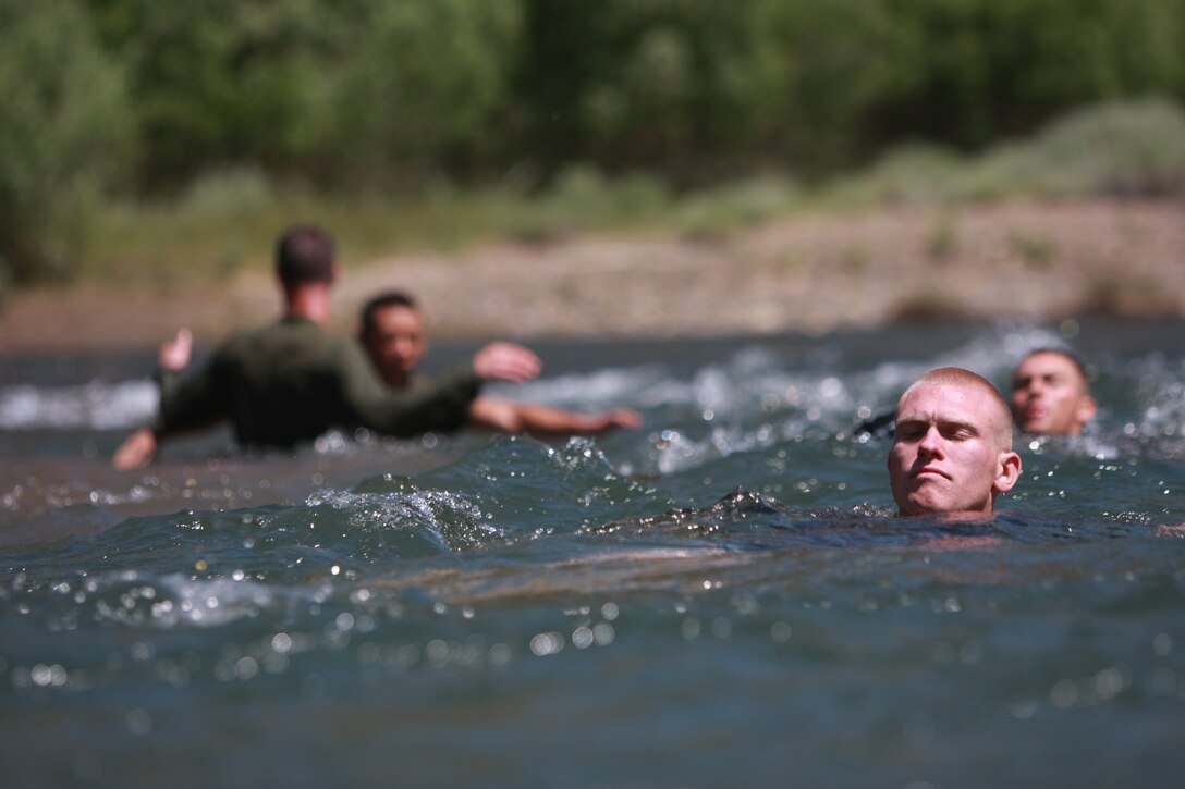 College students with the Naval Reserve Officer Training Corps swim across a stream at Mountain Warfare Training Center Bridgeport, Calif., July 5 when they received a taste of Marine Corps training.