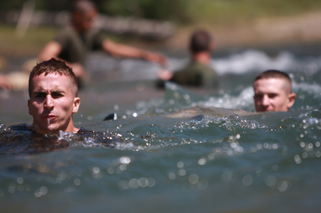 Naval Reserve Officer Training Corps midshipmen float down a stream July 5 at Mountain Warfare Training Center Bridgeport, Calif., when they learned to cross streams in mountainous terrain.