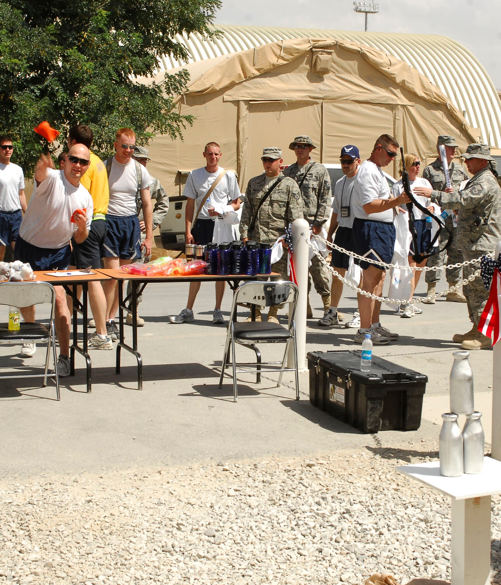 BAGRAM AIR FIELD, Afghanistan - Master Sergeant Robert Smith, 193rd Joint Special Operations, attempts to knock down all of the bottles during the Fourth of July Celebration, here. MSgt Smith hails from Camp Hill, Pa., and is attached to the Pennsylvania Air Guard.(U.S. Air Force Photo by Senior Airman Felicia Juenke)