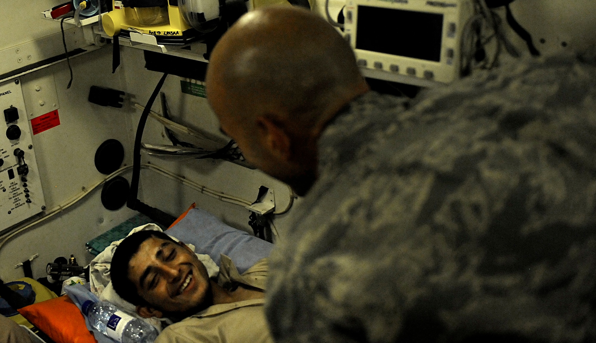 U.S. Air Force Capt. Jac Solghan, Aeromedical Evacuation Liaison Team flight clinical coordinator, comforts an Afghan boy who is returning home after weeks of care and rehabilitation by U.S. and Afghan medical personnel June 23, 2009, at Camp Bastion, Afghanistan. The boy lost his leg when a landmine exploded as he was walking along a road. (U.S. Air Force photo by Staff Sgt. Shawn Weismiller)
