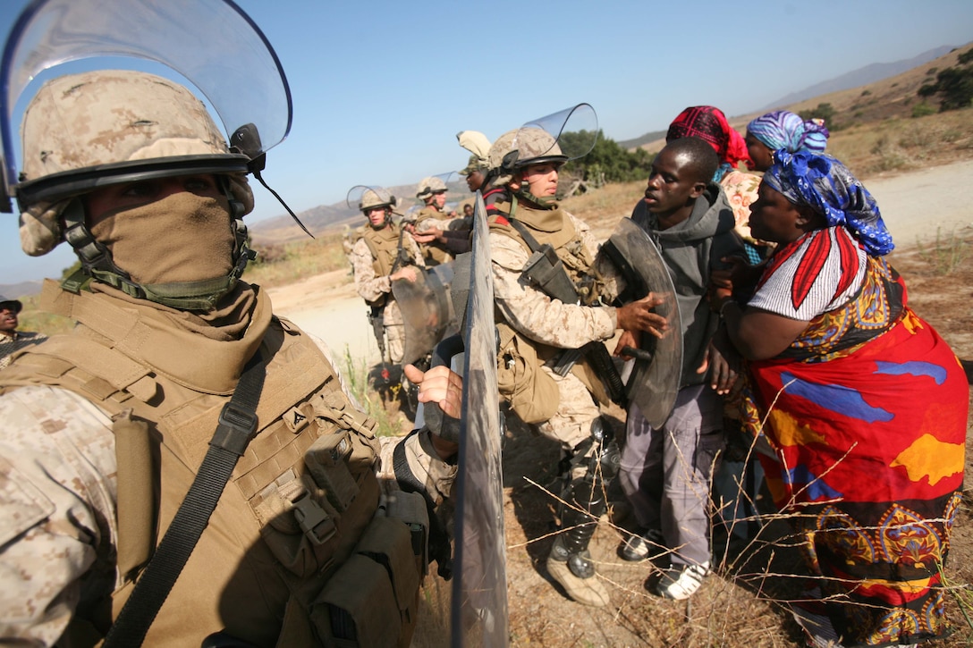 Marines with Battery A, 1st Battalion, 11th Marines, practice crowd control and giving aid to simulated refugees during a humanitarian aid exercise here July 5, 2005. The battery is attached to the ground combat element of the 11th Marine Expeditionary Unit, which is scheduled to deploy this fall. The MEU, part of the Bonhomme Richard Amphibious Ready Group, is conducting its first pre-deployment exercise at sea with its Navy counterpart, Amphibious Squadron 7. This Navy and Marine Corps team is testing interoperability before a deployment certification exercise later this summer.