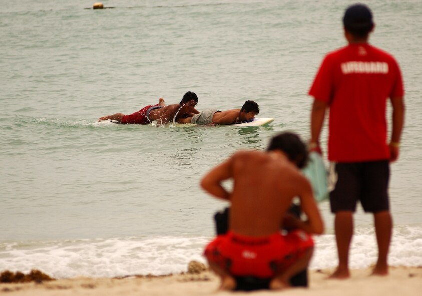 A lifeguard saves a drowned swimmer as part of a scenario during Kunigami Water Safety Day June 2 at the Japanese Airline Private Resort. The Detachment 1 unit in Okuma along with the adjacent cities provided a safety day to show the community basic water safety and a refresher on Cardiopulmonary Resuscitation. 
(U.S. Air Force photo/Tech. Sgt. Rey Ramon)             