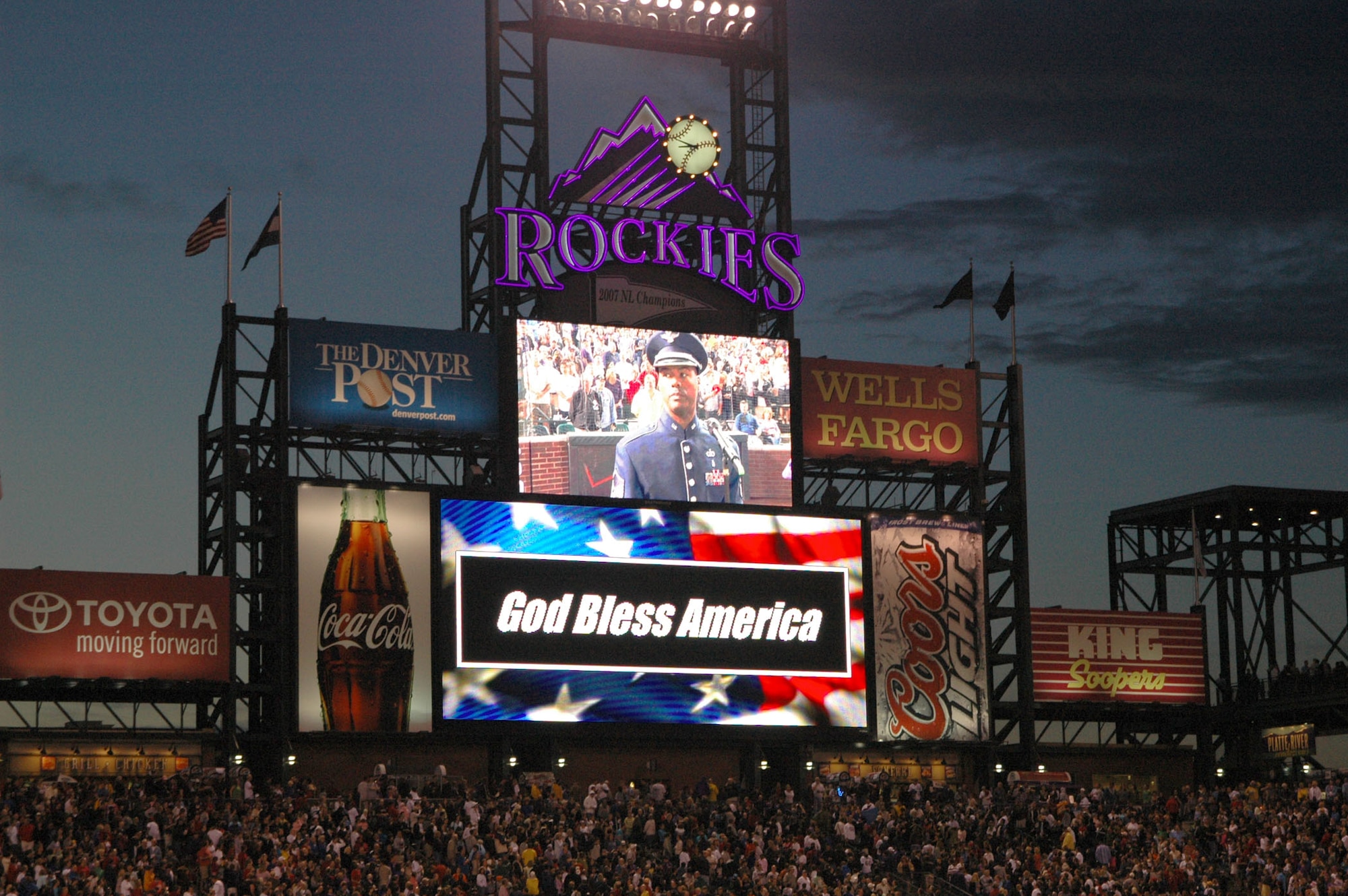 Master Sgt. Aaron Miles, a vocalist with the Air Force Reserve Command Band, is shown on the Coors Field 'jumbotron' before he sings the National Anthem July 4 at Coors Field in Denver. Sergeant Miles later presented a patriotic tone by singing the National Anthem in front of more than 51,000 fans, and during the game?s seventh-inning stretch, he also sang God Bless America to the roaring crowd in celebration of Independence Day. Coors Field is home to the Major League Baseball's Colorado Rockies. (U.S. Air Force photo/Ann Skarban)