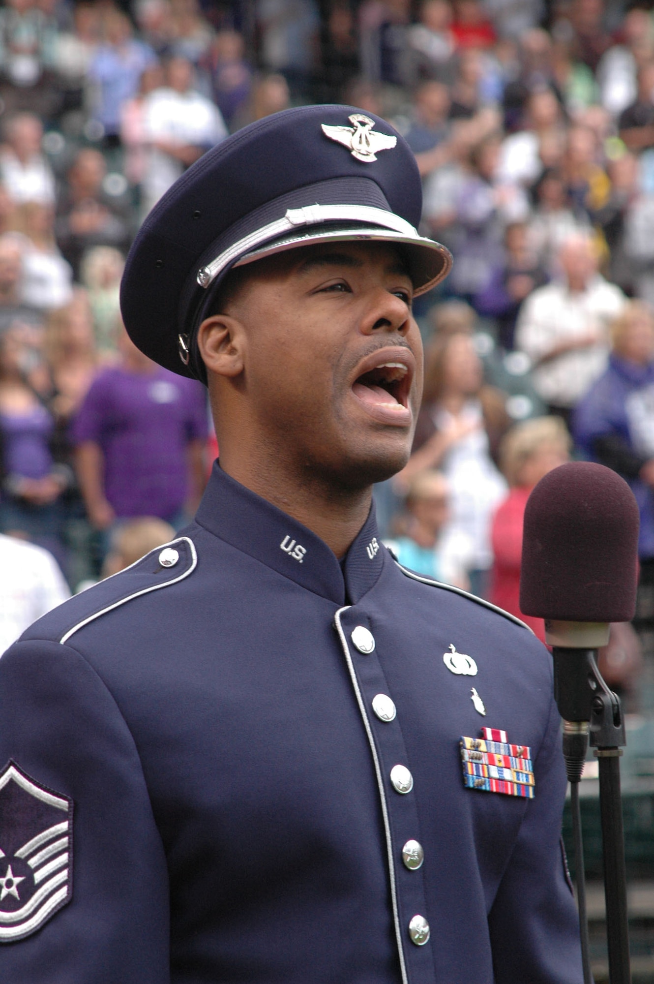 Master Sgt. Aaron Miles, a vocalist with the Air Force Reserve Command Band, sets a patriotic tone by singing the National Anthem July 4 at Coors Field in Denver. Sergeant Miles presented the Anthem in front of more than 51,000 fans, and during the game?s seventh-inning stretch, sang God Bless America to the roaring crowd in celebration of Independence Day. Coors Field is home to the Major League Baseball's Colorado Rockies. (U.S. Air Force photo/Ann Skarban)