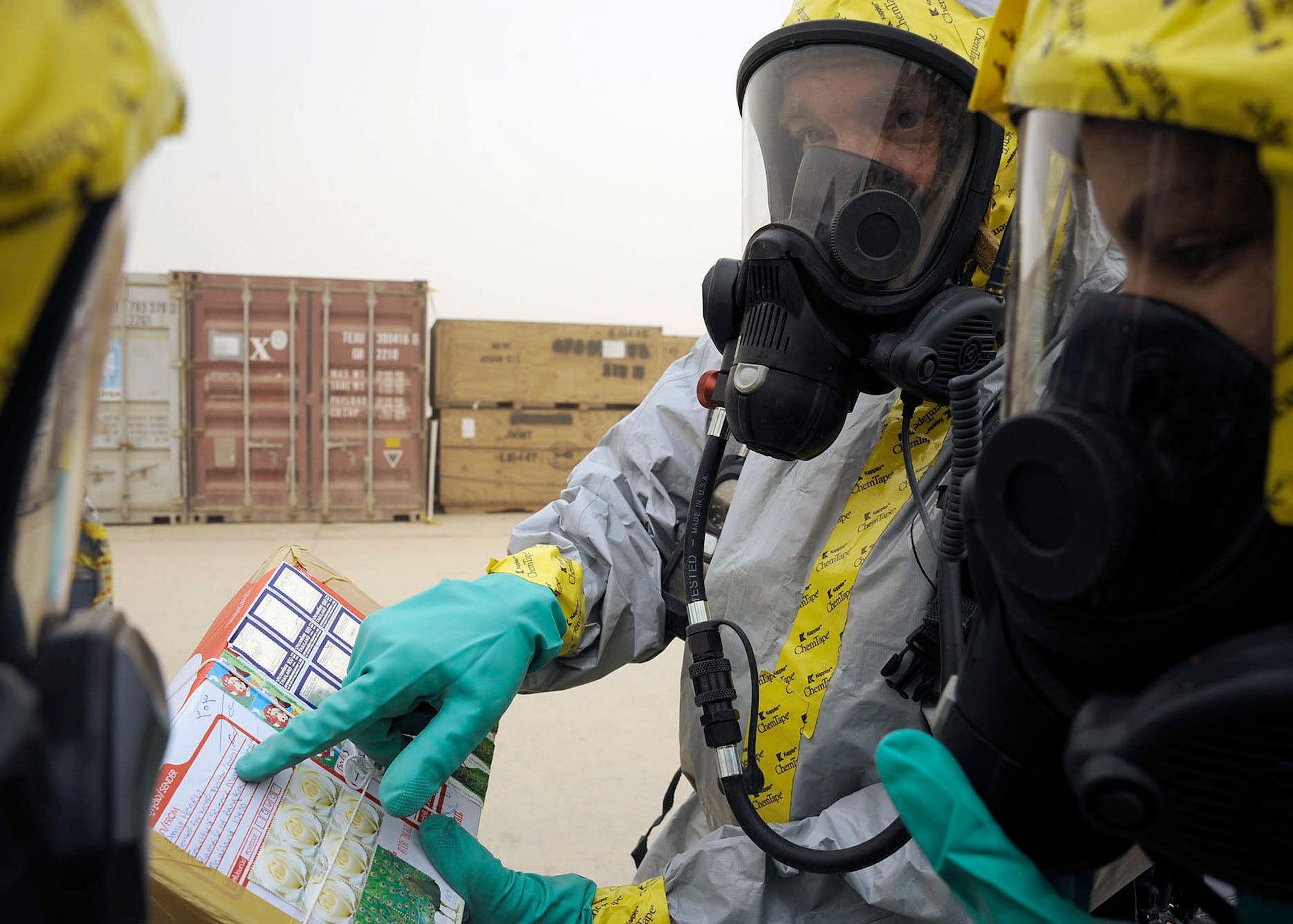 Tech. Sgt. Steve Gaunt points out unique writing on a package to Senior Airman Tyrone Fisher (left) and Senior Airman Lacye Branch (right) during a postal inspection recently at Camp Stryker, Iraq. Airman Fisher is deployed from the Indiana Air National Guard's 181st Intelligence Wing. Airman Branch is deployed from Nellis Air Force Base, Nev., and Sergeant Gaunt is deployed from Alabama Air National Guard's 117th Air Refueling Wing. (U.S. Air Force photo/Staff Sgt. Tim Beckham)