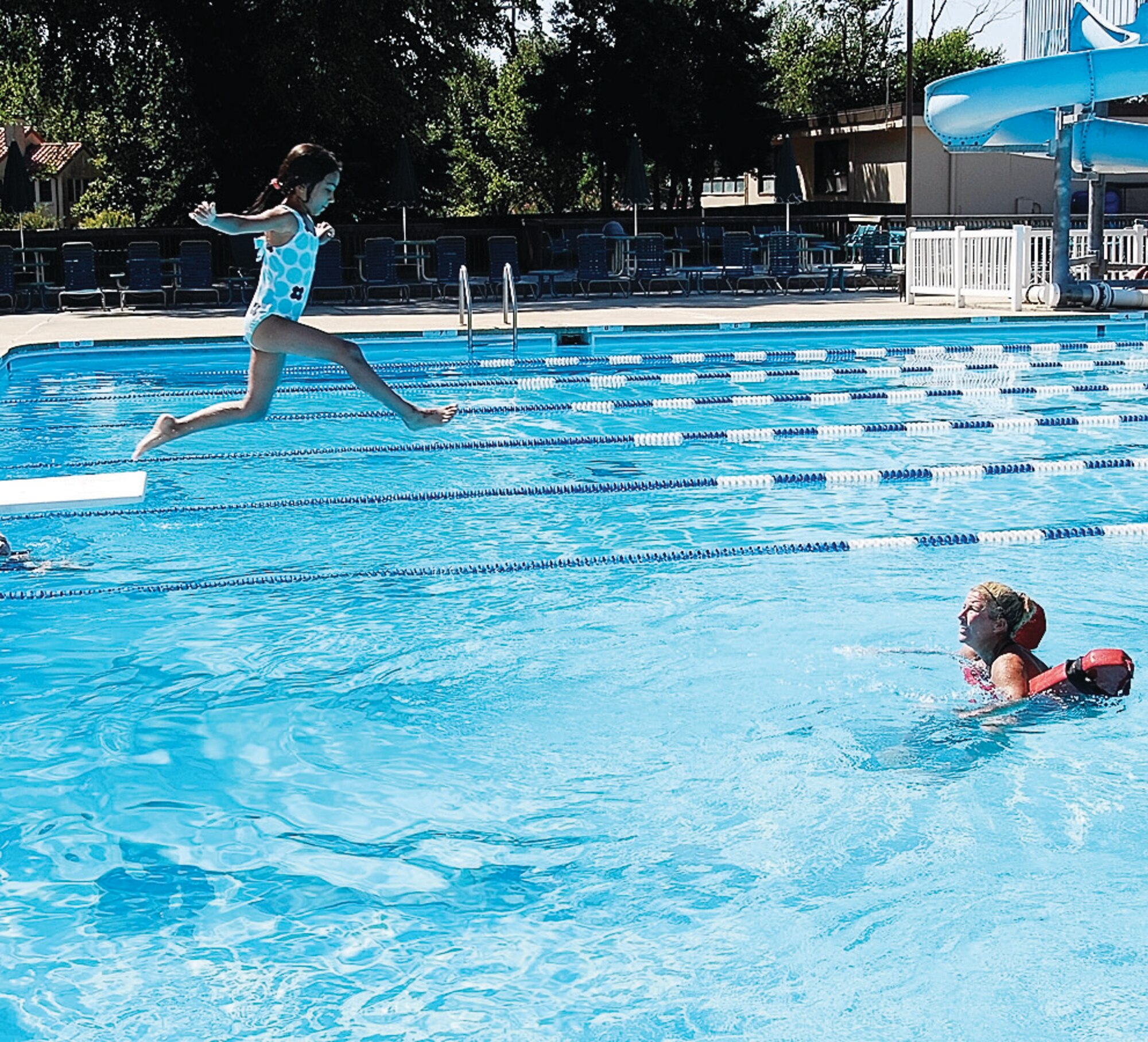 Sandhya Krishnaswamy, 5, jumps off the Pope Pool diving board during her swimming lesson June 30. Swimming lessons are held in two-week sessions Lessons are $25 per person per session with a total of eight sessions. Registration for youth swimming lessons is July 18 for Pope assigned personnel. (U.S. Air Force Photo by Rhonda Griffin)