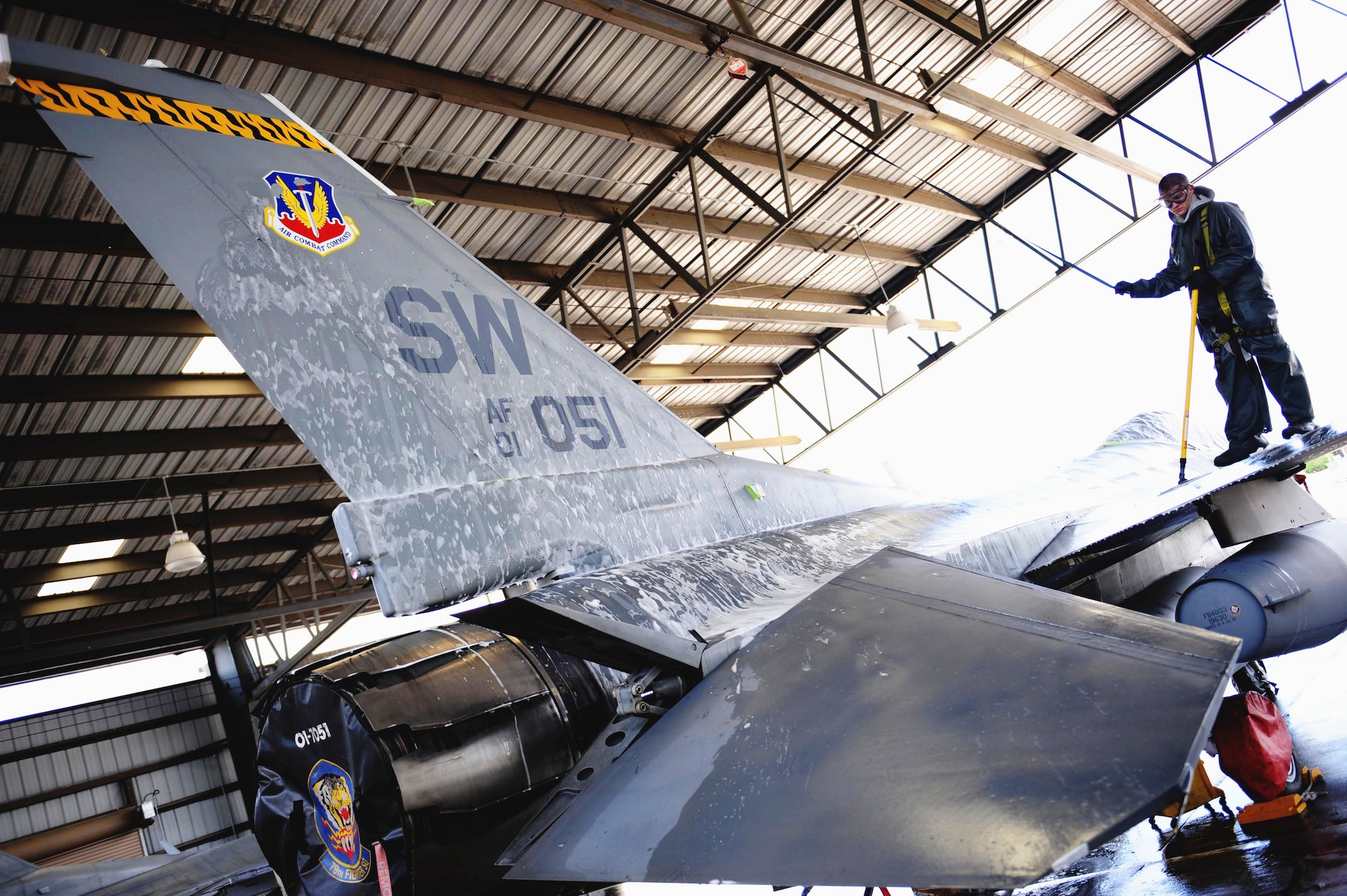Airman 1st Class Marcus Floyd washes an F-16 Fighting Falcon from the 79th Fighter Squadron at Shaw Air Force Base, S.C. Airmen from the 20th Maintenance Group were participating in an Air Force Smart Operations for the 21st Century rapid improvement event to enhance and improve wash rack operations for F-16 aircraft.  Airman Floyd is an armament specialist assigned to 20th Equipment Maintenance Squadron.  (U.S. Air Force photo/Senior Airman Matt Davis)
