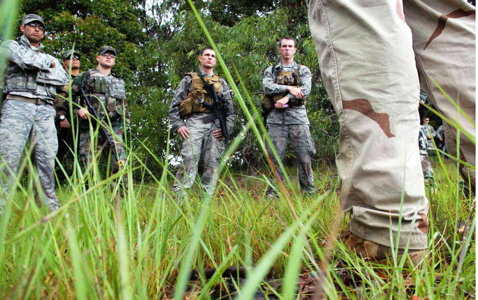 Tactical air control party Airmen trained with 25th Infantry Division Headquarters, Headquarters Company 114th Infantry Soldiers at Wheeler Army Airfield's East Range near Hickam Air Force Base, Hawaii, June 23-26. The 25th Air Support Operations Squadron partnered with the Army to glean information based on experiences the Soldiers have had in Iraq and Afghanistan recently to prepare for an upcoming 25th ASOS deployment. The training helped sharpen proficiencies necessary for radio operators, maintainers and drivers to become combat mission-ready joint terminal attack controllers. (U.S. Air Force photo/Senior Airman Carolyn Viss) 