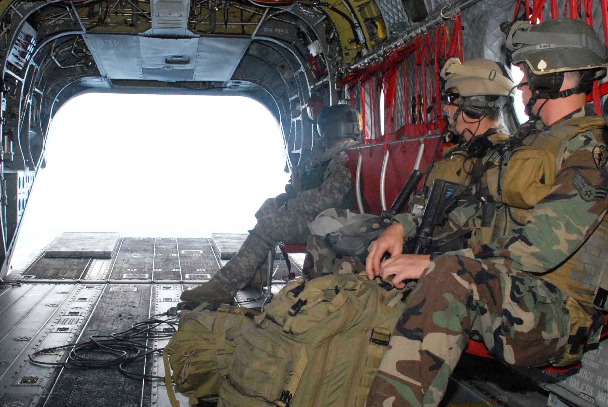 Tactical air control party Airmen prepare for landing after a 30-minute ride on an Army National Guard CH-47 Chinook during training June 23-26. 25th Air Support Operations Squadron Airmen camped at Wheeler Army Airfield's East Range near Hickam Air Force Base, Hawaii, to sharpen proficiencies necessary for upgrade training to become combat mission-ready joint terminal attack controllers. It's training like this that ensures safe and reliable wartime readiness. (U.S. Air Force photo/Senior Airman Carolyn Viss) 