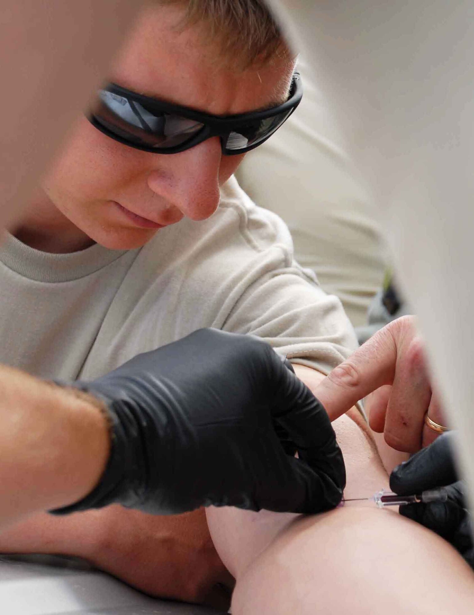 Airman 1st Class Doug Fraites, 25th Air Support Operations Squadron ground radio maintenance, gives Airman 1st Class Cory Aita fluids through an intravenous catheter in the field June 25. Soldiers helped train 25th Air Support Operations Squadron tactical air control party members to become combat mission-ready joint terminal attack controllers. When deployed, these young men are stationed with Army combat units and are responsible for calling in close-air support. As combat Airmen, their jobs incorporate expertise above and beyond what's normally required of warriors in blue. (U.S. Air Force photo/Senior Airman Carolyn Viss) 

