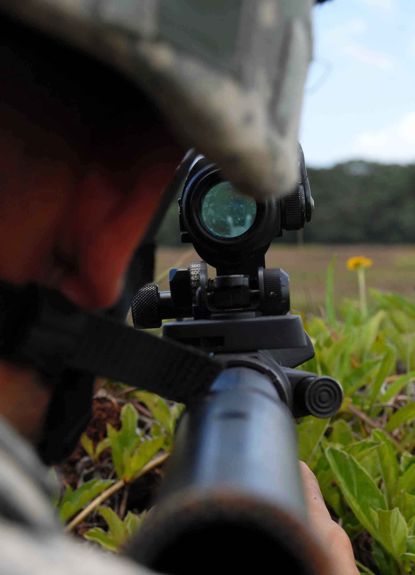 Airman 1st Class Doug Fraites, 25th Air Support Operations Squadron ground radio maintenance, secures a perimeter for a landing zone at Wheeler Army Airfield's East Range near Hickam Air Force Base, Hawaii, June 24. Training included combat lifesaver skills, convoys, air assault egression and improvised explosive device reaction and will give tactical air control party members a better idea of what to expect when they deploy to Afghanistan with an Army unit. (U.S. Air Force photo/Senior Airman Carolyn Viss) 
