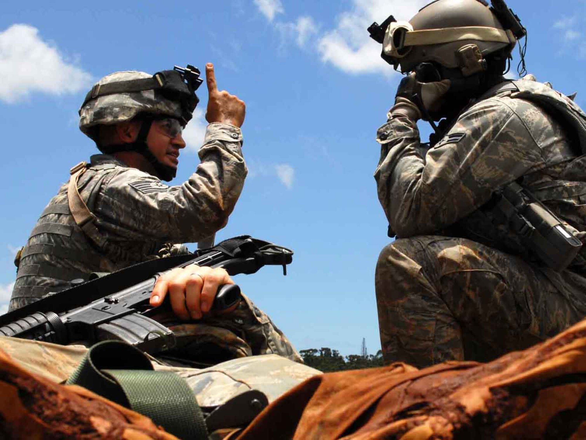 Tech. Sgt. Alejandro Castillo indicates to Airman 1st Class Chris Tamblyn, 25th Air Support Operations Squadron tactical air control party, to prepare to load a casualty on a CH-47 Chinook for aeromedical evacuation during field training June 24. Radio operators, maintainers and drivers camped out for four days to sharpen proficiencies necessary for upgrade training to become combat mission-ready joint terminal attack controllers. Because they're training now, they'll have a better idea of what to expect when they get to Afghanistan with an Army unit. (U.S. Air Force photo/Senior Airman Carolyn Viss) 
