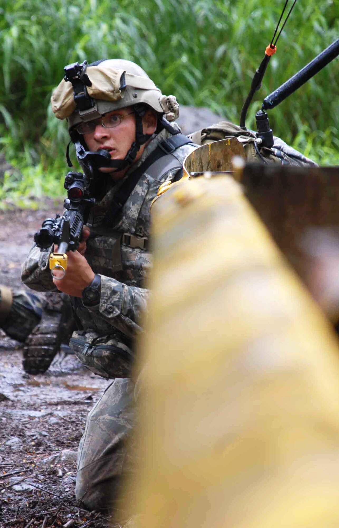 Airman 1st Class Chris Tamblyn, 25th Air Support Operations Squadron Tactical Air Control Party, provides small-arms fire cover for members of his unit who were evading opposing forces during a field training exercise here June 23. Armed with M-16s and basic radio and global positioning system equipment, they made their way through wet brush to find their camping spot and were "ambushed" along the way by pseudo attackers. Training like this ensures safe and reliable wartime readiness for TACPs. (U.S. Air Force photo/Senior Airman Carolyn Viss) 
