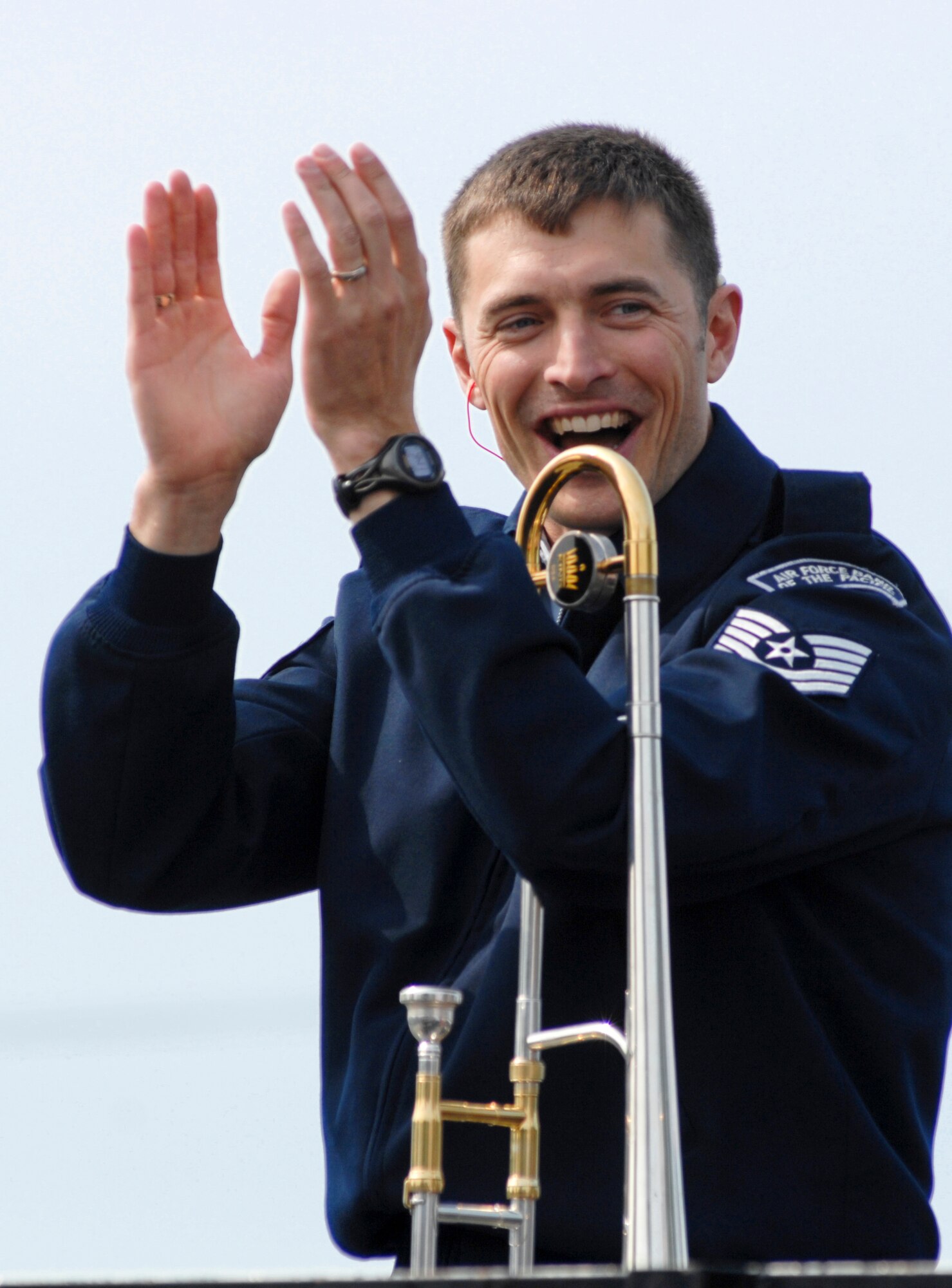 ANCHORAGE, Alaska -- Tech. Sgt. David McCormick claps along with the audience during the U.S. Air Force Band of the Pacific's performance during the Fourth of July Parade here. McCormick is a member of the PACAF Band. (U.S. Air Force photo/Senior Airman David Carbajal)