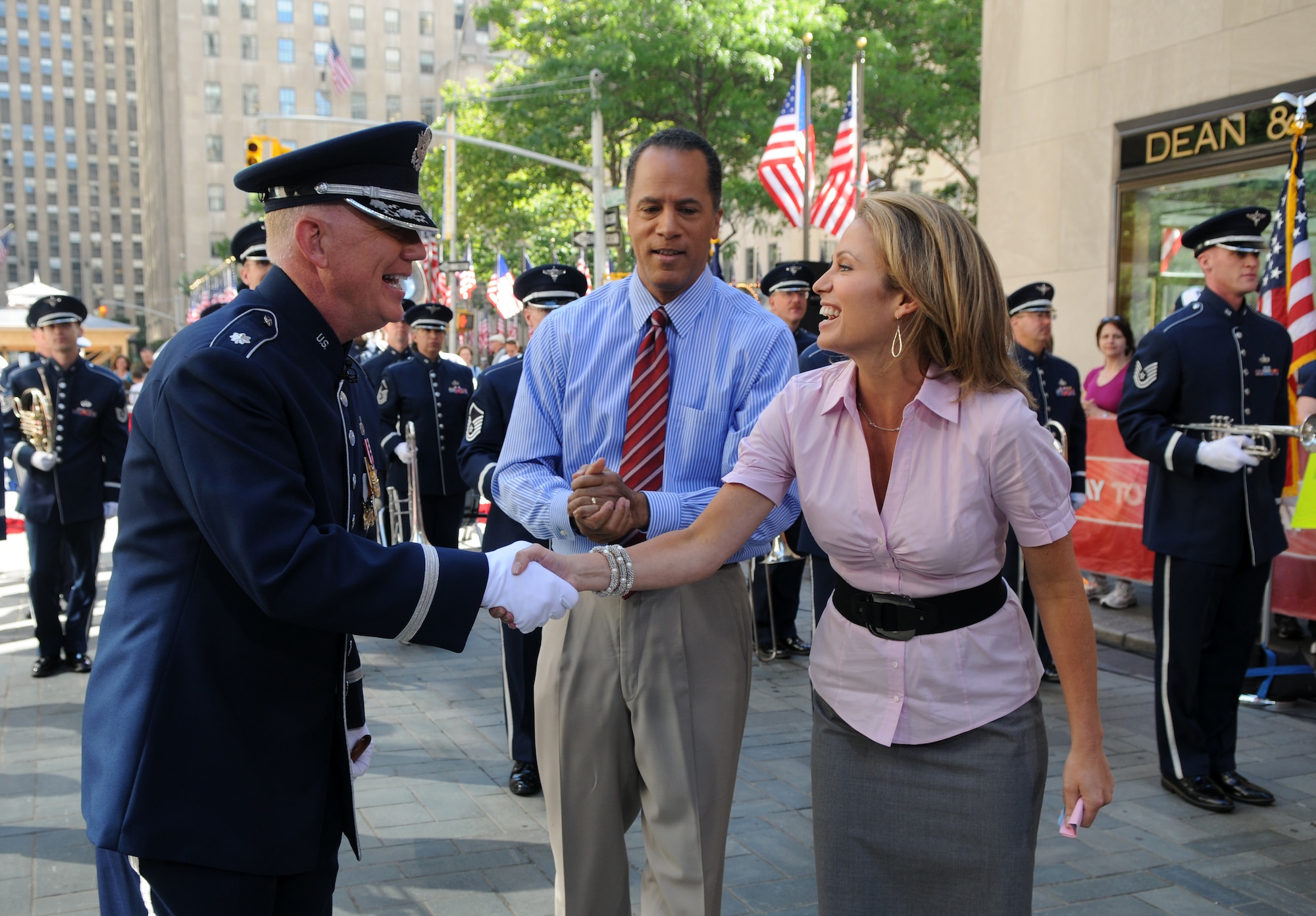 Lt. Col. Alan Sierichs, United States Air Force Band commander, meets with "Today" show hosts Lester Holt and Amy Robach during a live Independence Day broadcast from Rockefeller Plaza in New York City. The Ceremonial Brass has performed annually on the Today show since 1998. (U.S. Air Force photo by Senior Airman Marleah Miller)