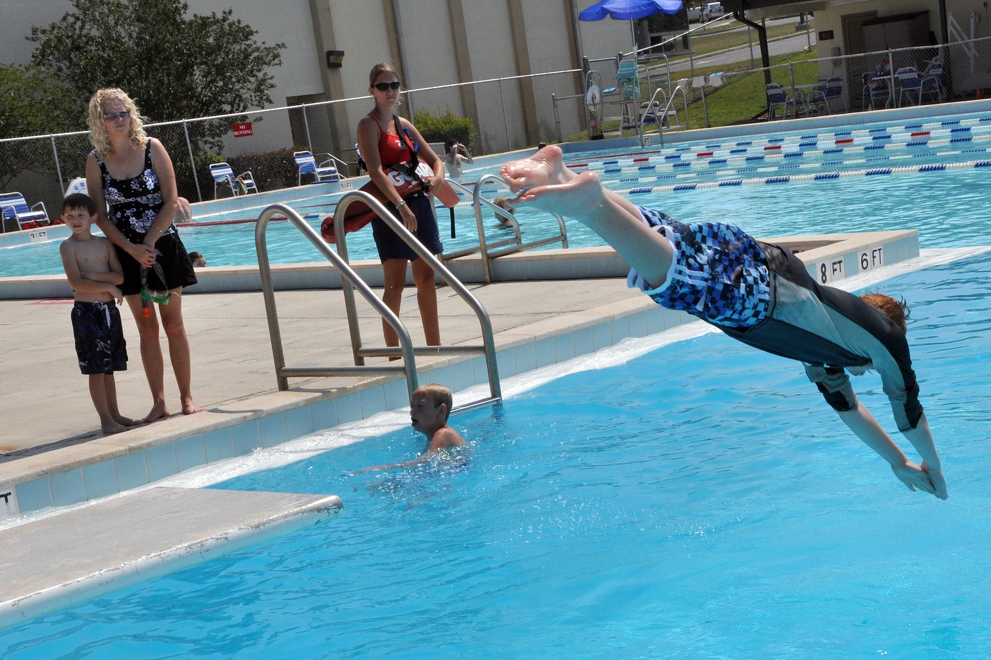 EGLIN AIR FORCE BASE, Fla. – A child dives into the East Gate pool June 16, under the careful watch of a lifeguard. The pool is open 6:30 am-6:30 pm, every day except Wednesday to anyone with a military ID for a fee of $2 per person. (U.S. Air Force photo/ Airman Anthony Jennings)