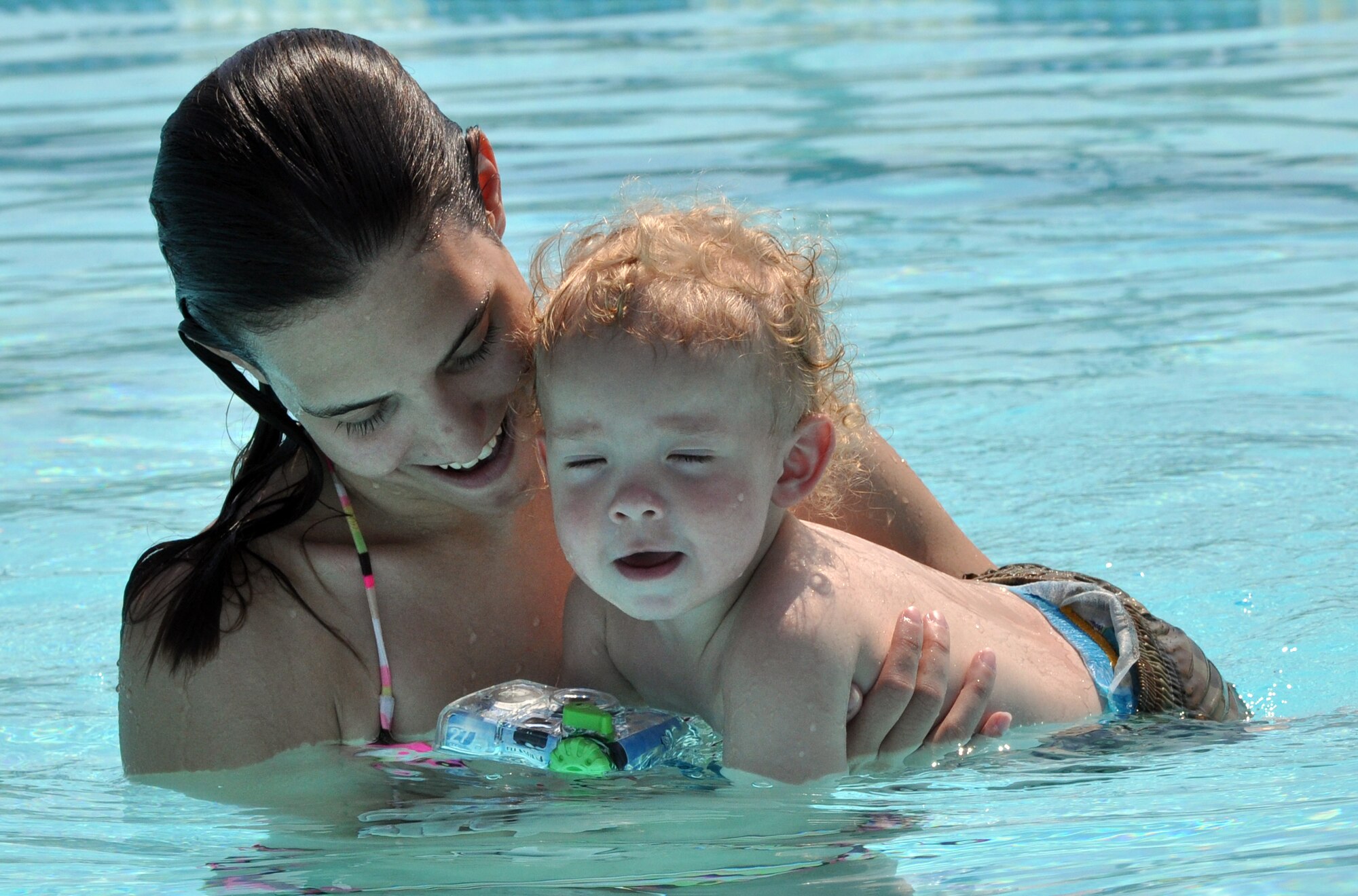 EGLIN AIR FORCE BASE, Fla. – A mother introduces her child to the water at the East Gate pool June 16. The pool is open 6:30 am-6:30 pm, every day except Wednesday to anyone with a military ID for a fee of $2 per person. (U.S. Air Force photo/ Airman Anthony Jennings)