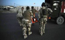 Staff Sgt. William Lawson, right, a pararescuemen with the 129th Expeditionary Rescue Squadron helps carry a wounded Afghan National Army soldier to an ambulance at Kandahar Airfield, Afghanistan, June 27. (U.S. Air Force photo/Staff Sgt. Shawn Weismiller)