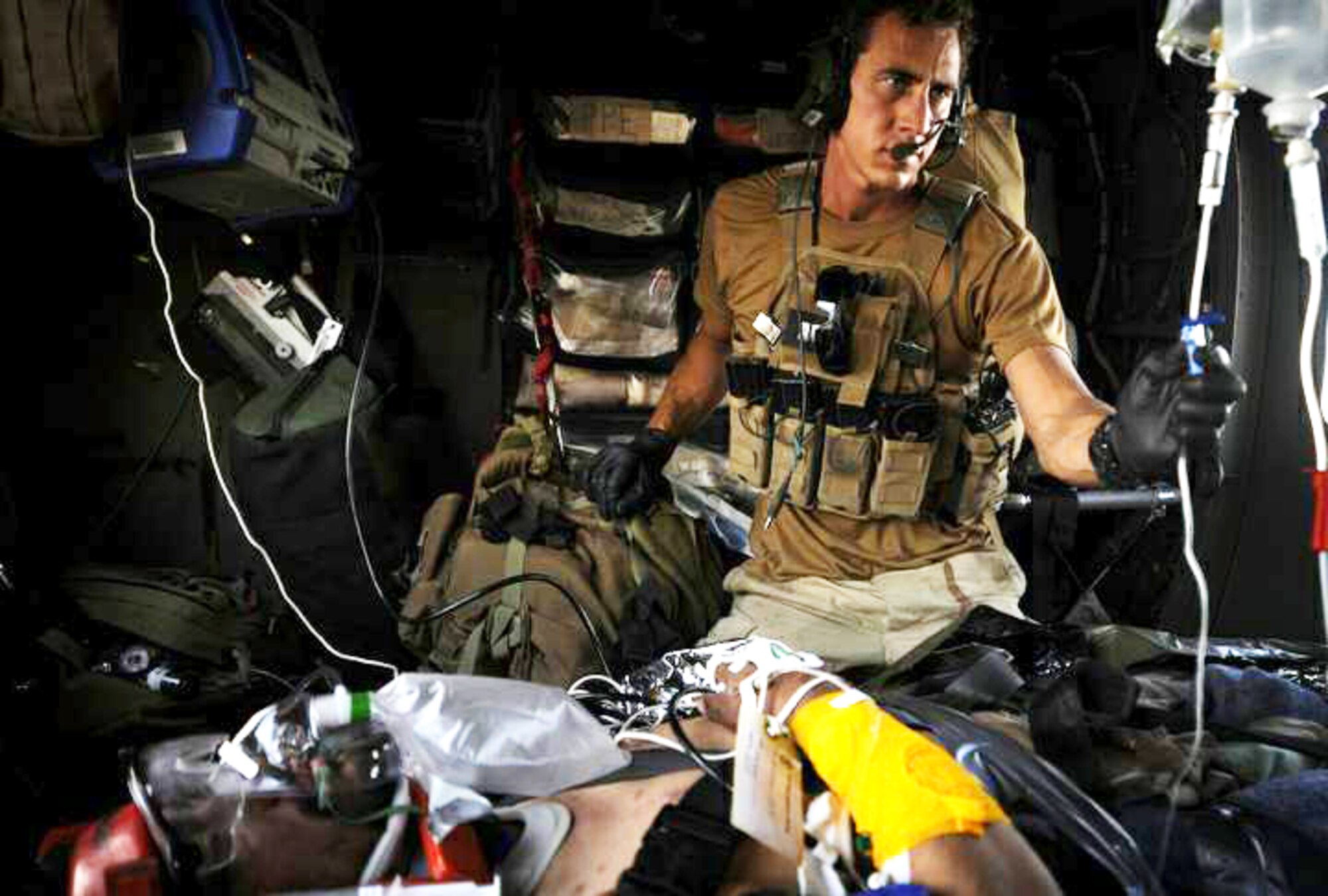 Senior Airman Noah Landwerlen cares for a patient while waiting for a wounded Afghan National Army soldier to be loaded into an HH-60G Pave Hawk in the Hemalnd Province, Afghanistan,  June 27. Airman Landwerlen is a pararescueman with the 129th Expeditionary Rescue Squadron. The 129th ERSQ responds to emergency medical evacuation calls within the province, providing casualty evacuation and personnel recovery/combat search and rescue in support of Regional Command South. (U.S. Air Force photo/Staff Sgt. Shawn Weismiller)