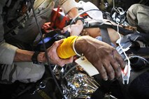 Pararescuemen from the 129th Expeditionary Rescue Squadron care for a wounded Afghan National Army soldier aboard an HH-60G Pave Hawk over the Hemland Province, Afghanistan, June 27. Pararescuemen are trained paramedics who provide care to the injured sevicemembers until they can be safely delivered to a hospital. (U.S. Air Force photo/Staff Sgt. Shawn Weismiller)