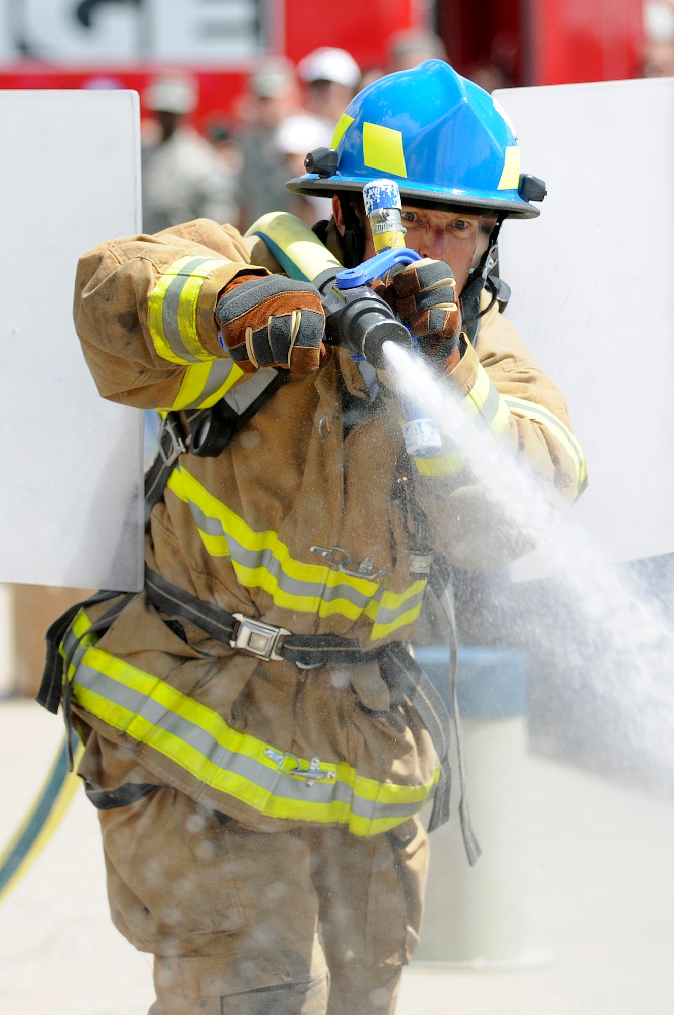 Firefighter Mark Caraway of the USAFA Anchors relay team takes aim at a volleyball-sized target during a regional Firefighter Challenge held at the U.S. Air Force Academy, Colo., June 26-27. (U.S. Air Force photo/Mike Kaplan)