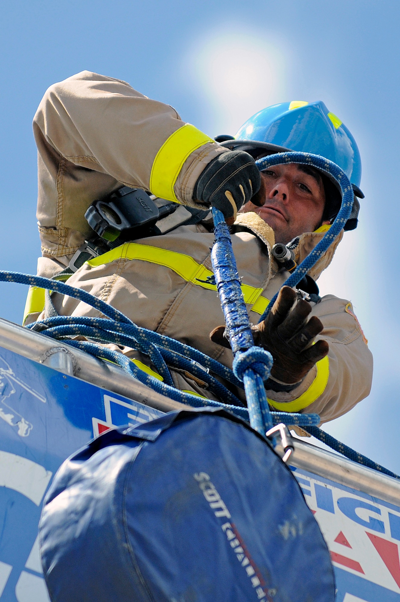 Team USAFA relay member firefighter Steve Hardman hoists a 45-pound hose up a five-story tower during a regional Firefighter Challenge at the U.S. Air Force Academy, Colo., June 27. (U.S. Air Force photo/Mike Kaplan)