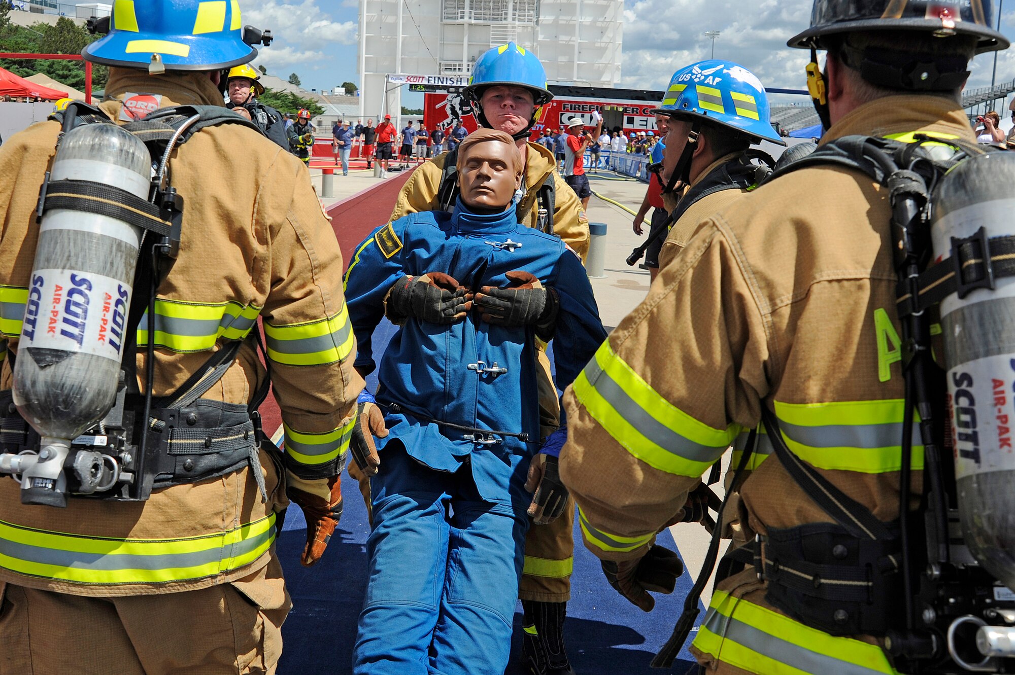 Airman 1st Class Matthew Murrell drags a 175-pound life-size "Rescue Randy" mannequin during the final leg of a relay during a regional Firefighter Challenge held June 26-27 at the U.S. Air Force Academy in Colorado Springs, Colo. (U.S. Air Force photo/Mike Kaplan)