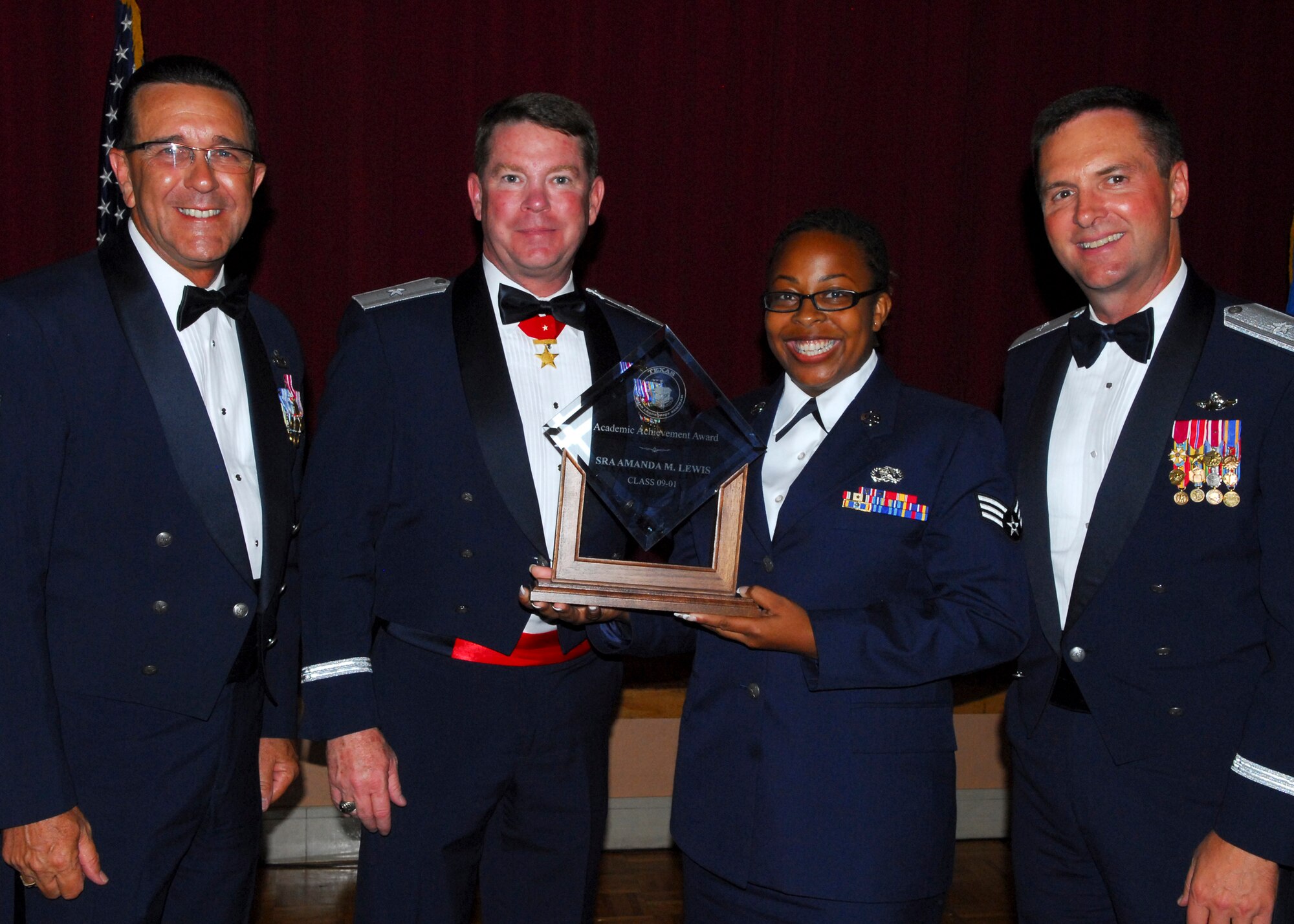 Senior Airman Amanda M. Lewis of the 149th Fighter Wing receives the Academic Achievement Award in the Texas Airman Leadership School graduation ceremony held June 26 in San Antonio.  38 senior airmen from the three Texas wings and geographically separated units attended the two-week Professional Military Education course.  Air National Guard photo by Senior Master Sgt. Miguel Arellano. 