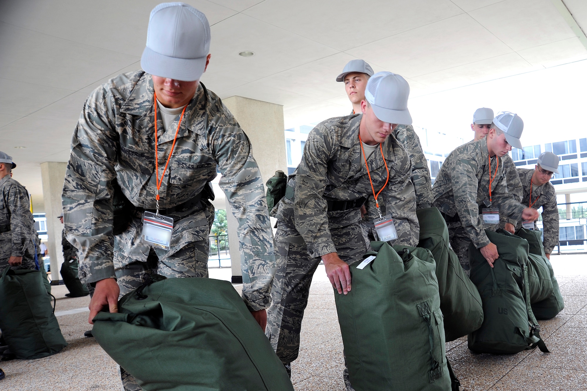 Basic cadets pack issued equipment into duffelbags during Class of 2013 cadet inprocessing at the U.S. Air Force Academy in Colorado Springs, Colo., June 25. Issue items include Airman Battle Uniforms and physical training uniforms. (U.S. Air Force photo/Mike Kaplan)