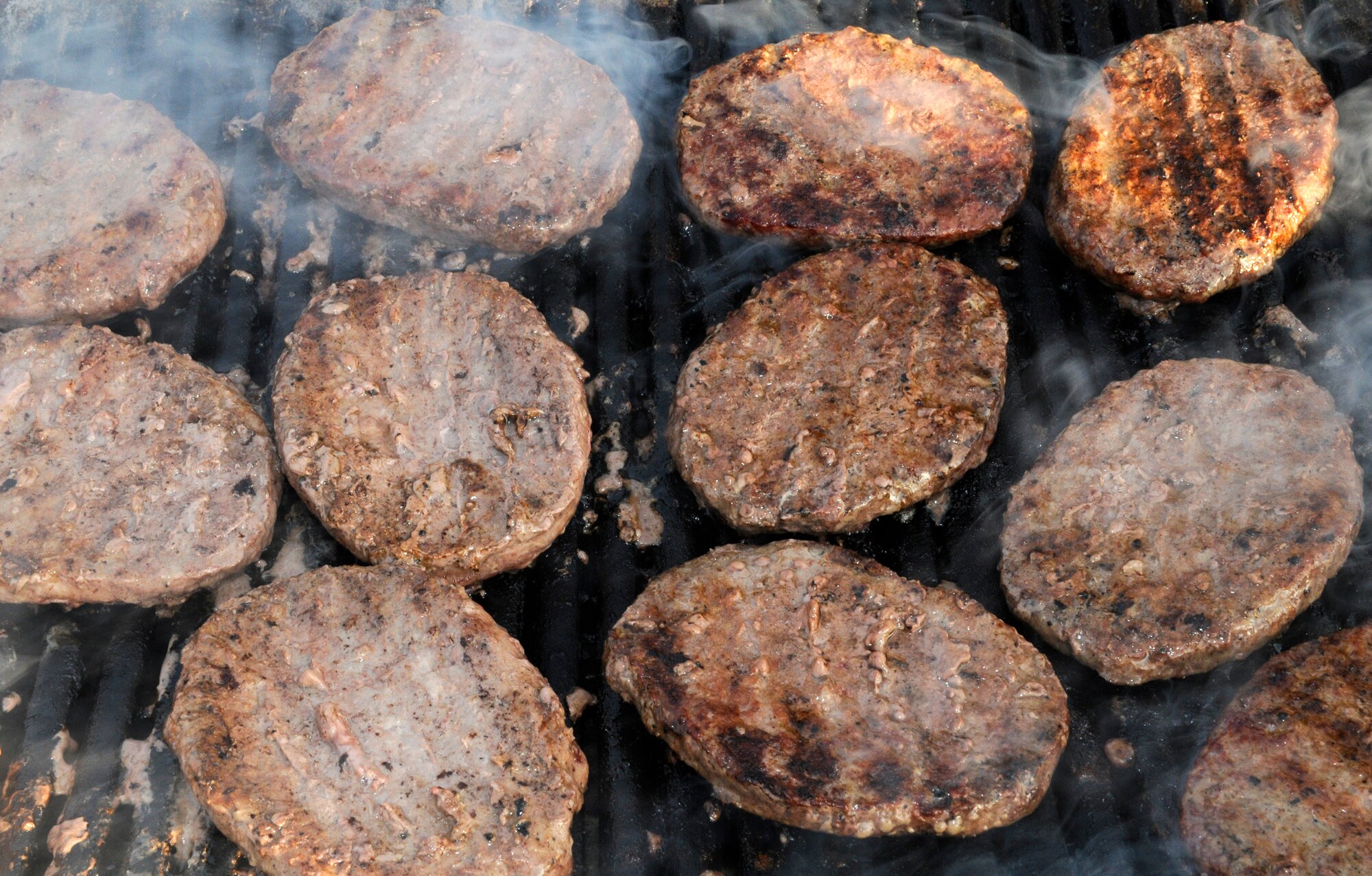 The classic American hamburger sizzles on a hot barbeque during the Independence Day celebration at RAF Feltwell.  The hamburger booth was one of several food venders that sold everything from southern fried chicken to cotton candy.  (U.S. Air Force photo by Staff Sgt. Christopher L. Ingersoll)