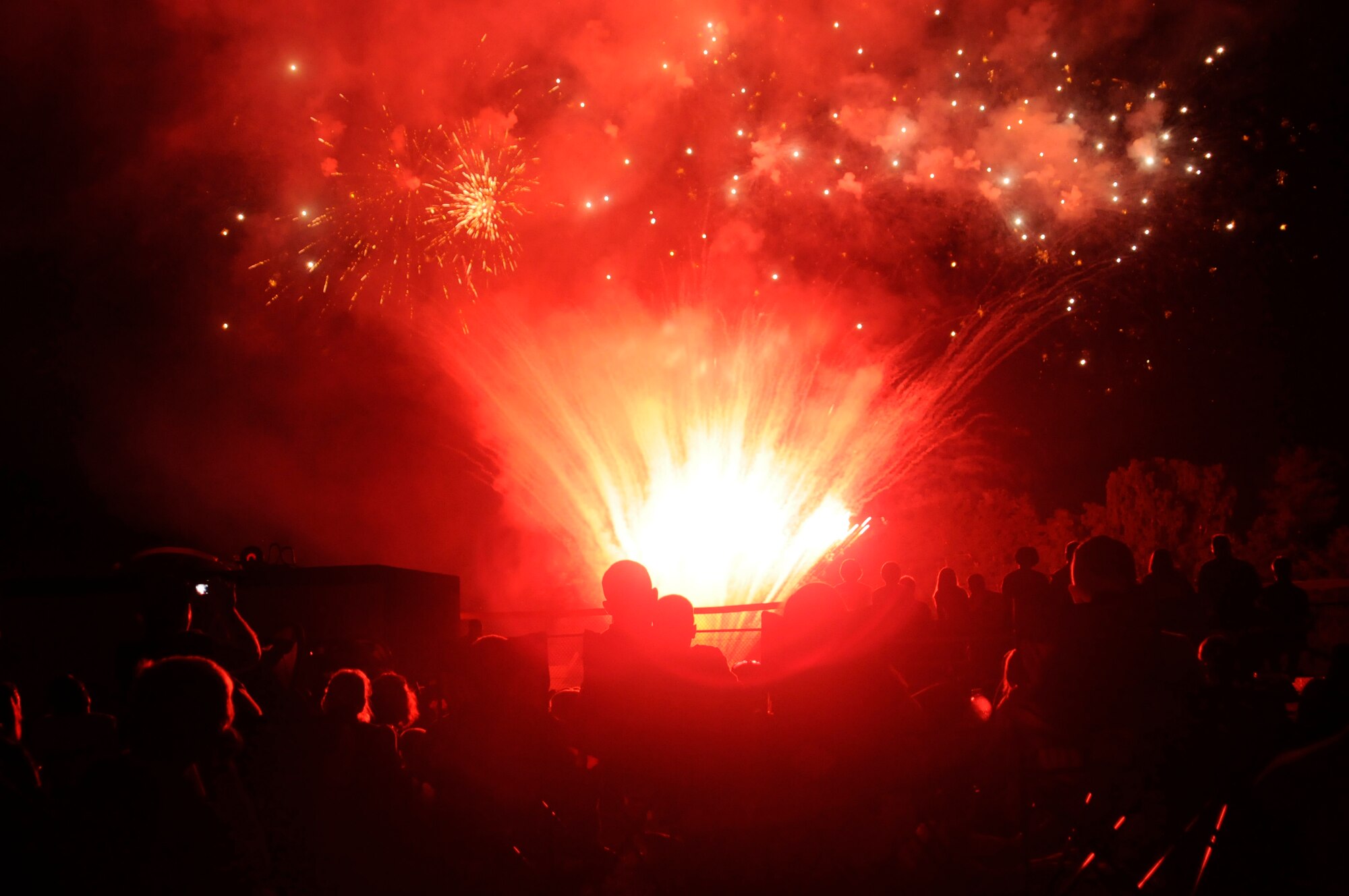 Members of the Kaiserslautern Military Community watch the firework display, July 4, 2009, Kapaun Air Station, Germany. The KMC celebrated the Rockin’ Fourth of July event with games, rides and concerts and ended the night with fireworks. (U.S. Air Force photo by Tech. Sgt. Kenneth Bellard)