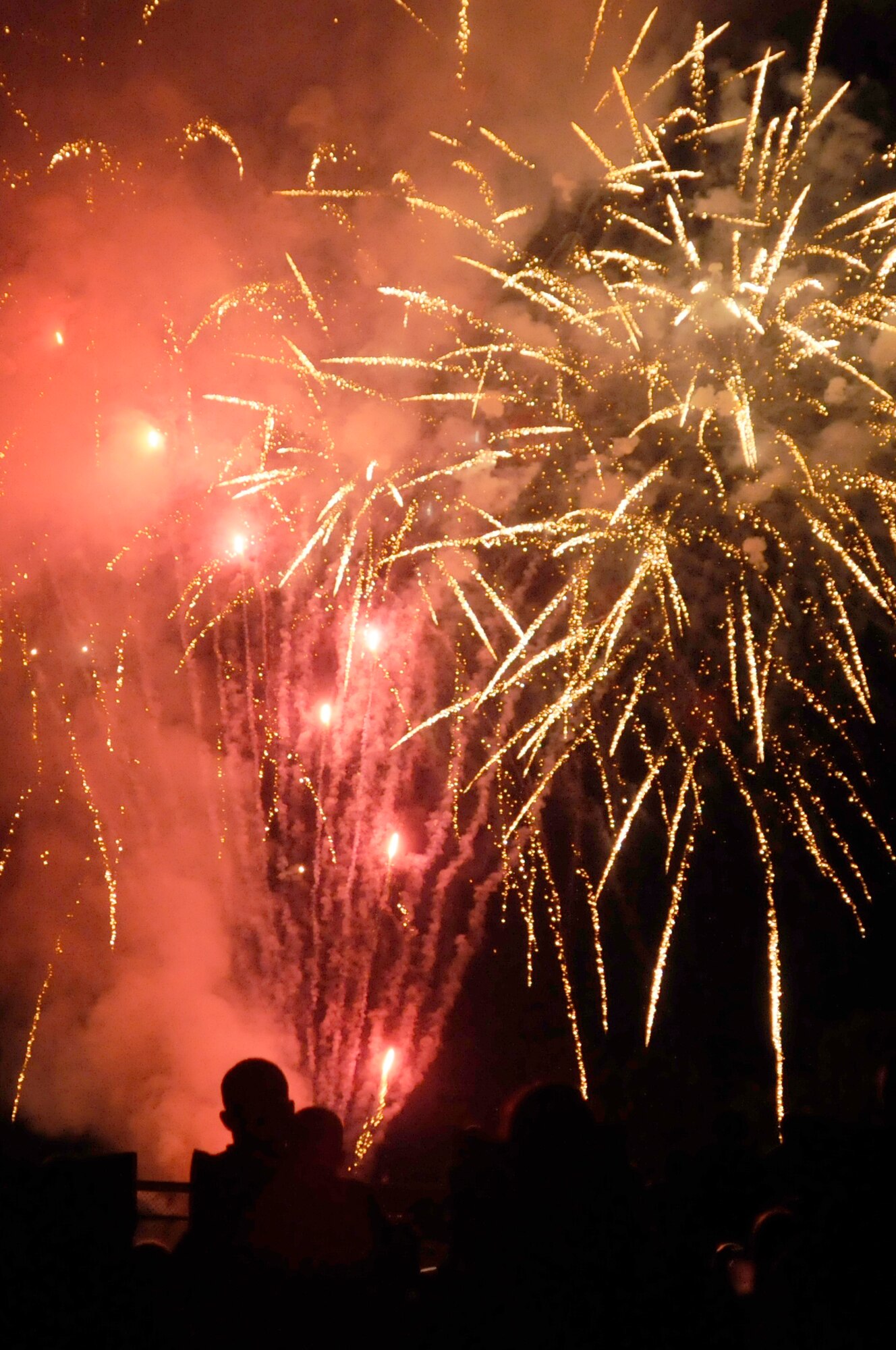 Members of the Kaiserslautern Military Community watch the firework display, July 4, 2009, Kapaun Air Station, Germany. The KMC celebrated the Rockin’ Fourth of July event with games, rides and concerts and ended the night with fireworks. (U.S. Air Force photo by Tech. Sgt. Kenneth Bellard)
