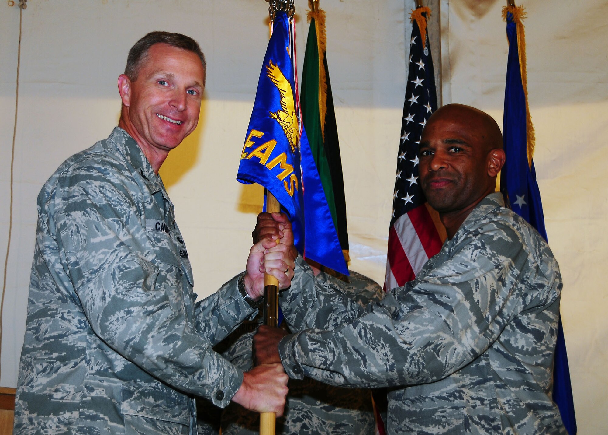 Lt. Col. Mike Carter assumes command of the 5th Expeditionary Air Mobility Squadron, by accepting the guidon from Col. Gordon Campbell, 521st Air Mobility Operations Group commander, during a change of command ceremony in Southwest Asia July 5.  (U.S. Air Force photo/Tech. Sgt. Tony Tolley)