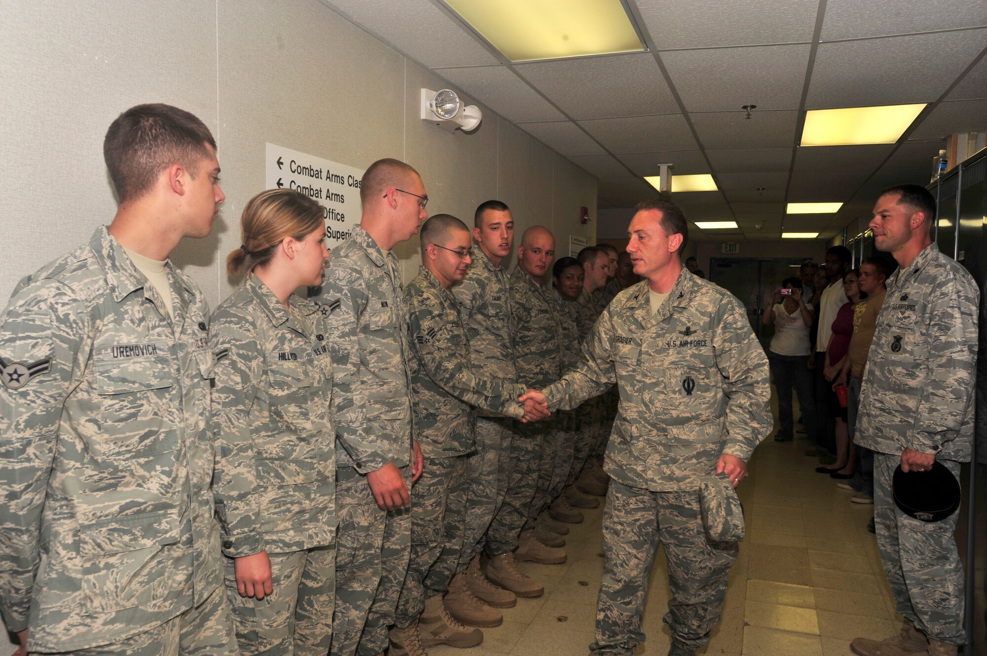 BUCKLEY AIR FORCE BASE, Colo. -- Col. Clint Crosier, 460th Space Wing commander, shakes hands with Security Forces Squadron members prior to their departure for a deployment in support of Operation Iraqi Freedom here, Jun 25. (U.S. Air Force photo by Staff Sgt. Anika Williams)
