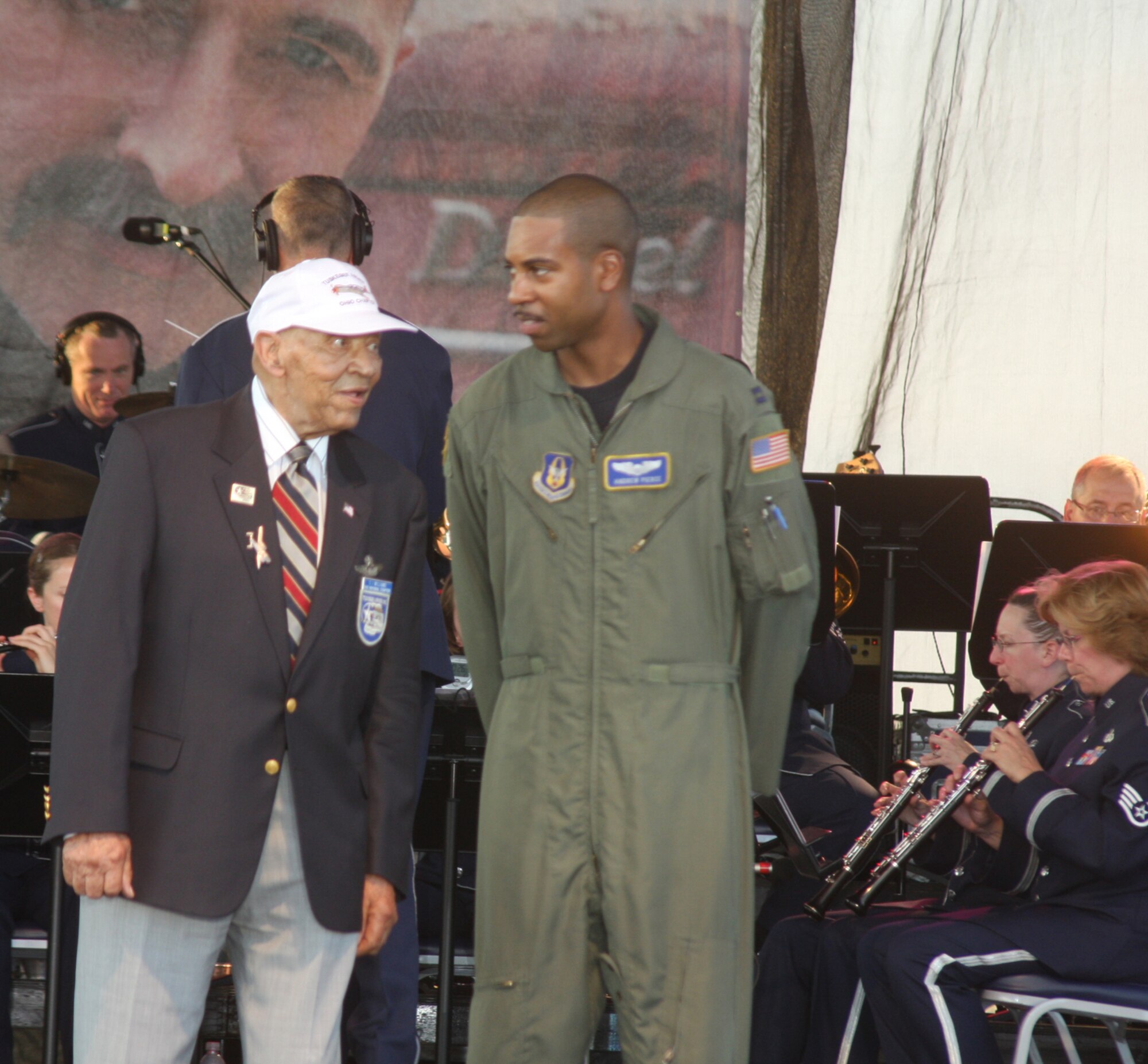 WRIGHT-PATTERSON AIR FORCE BASE, Ohio - Capt. Andrew Pierce, 89th Airlift Squadron, escorts C. I. Williams on stage during a special recognition of World War II honorees during the June 26 AFMC's Freedom's Call Tattoo 2009. Mr. Williams enlisted in the military more than 65 years ago and is reportedly the oldest living Tuskegee Airman. (Air Force photo/Staff Sgt. Ken LaRock)