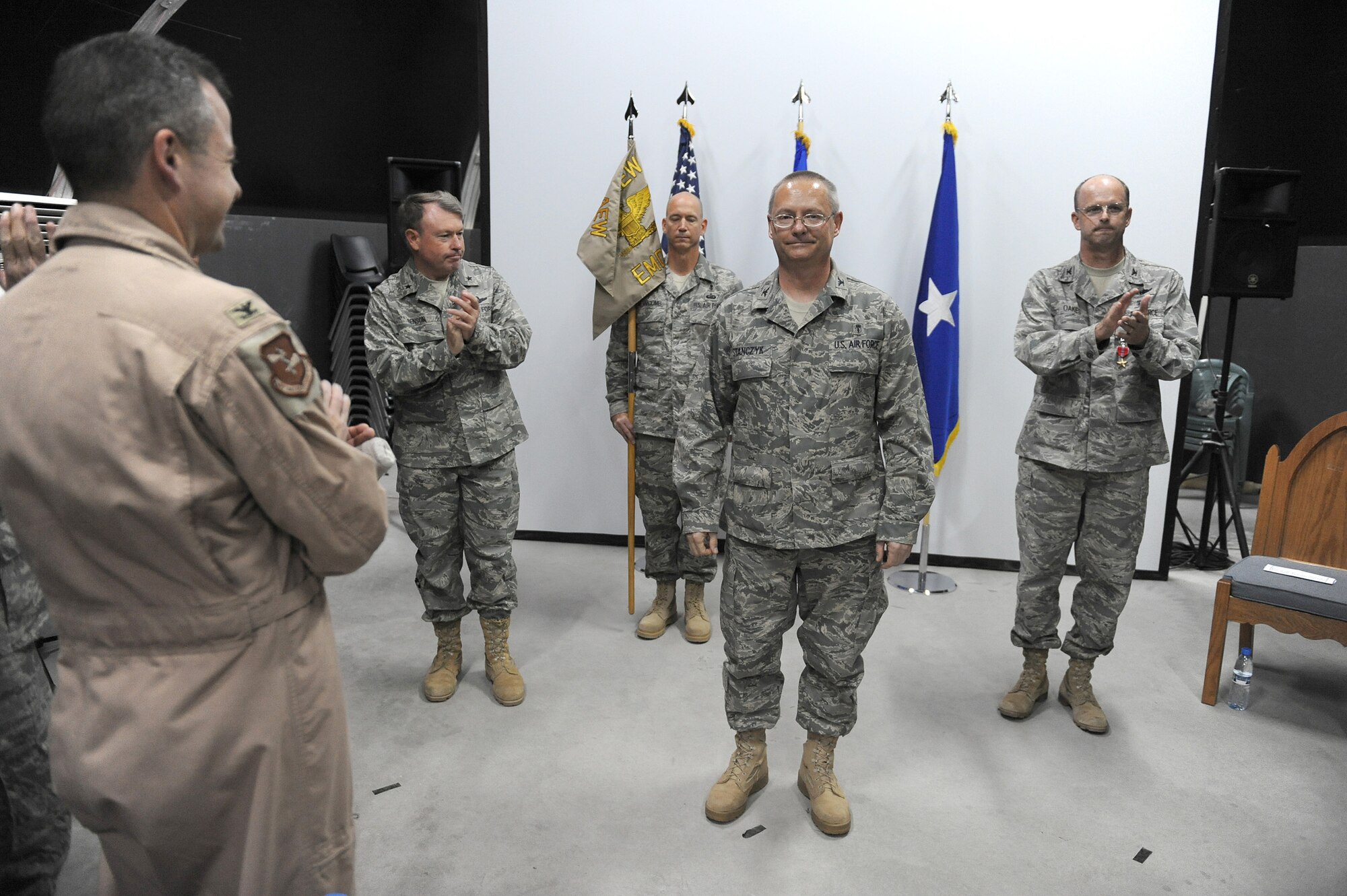SOUTHWEST ASIA - Col. David Stanczyk is applauded by Airmen of the 380th Air Expeditionary Wing after he took command of the 380th Expeditionary Medical Group during a ceremony, July 2 at an undisclosed location in Southwest Asia. Colonel Stanczyk comes from Little Rock AFB, Ark. joining the 380th Air Expeditionary Wing to lead the 380th EMDG. (U.S. Air Force photo by Senior Airman Brian J. Ellis)