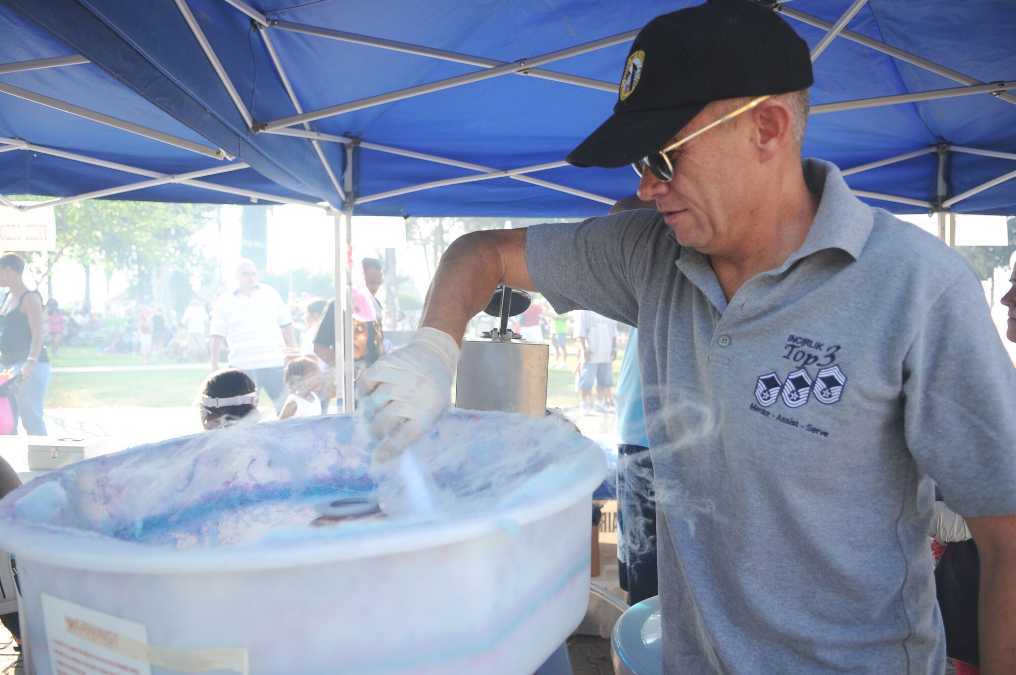 Senior Master Sgt. Johnny Jesse, the 39th Operations Squadron’s “Cotton Candy King,” prepares an order of cotton candy during Freedom Fest July 4 at Incirlik Air Base, Turkey. Sergeant Jesse volunteered at the Air Force Sergeant’s Association concession booth. Freedom Fest was the base’s official Fourth of July celebration and included events such as live bands, concession stands, arts and crafts, a petting zoo and a fireworks show. (U.S. Air Force photo/Senior Airman Alex Martinez)