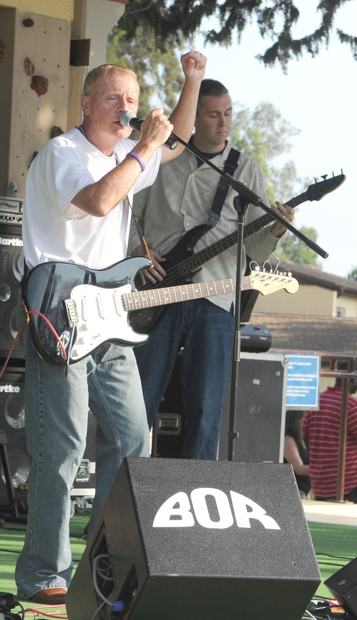 Singer and songwriter Mark Warner, 39th Force Support Squadron, encourages the crowd to get “pumped up” during his band’s Freedom Fest performance Saturday, July 4, 2009 at Incirlik Air Base, Turkey. The band’s name is The Sun Spots. Freedom Fest was the base’s official Fourth of July celebration and included events such as live bands, concession stands, arts and crafts, a petting zoo and a fireworks show. (U.S. Air Force Photo/Senior Airman Alex Martinez)