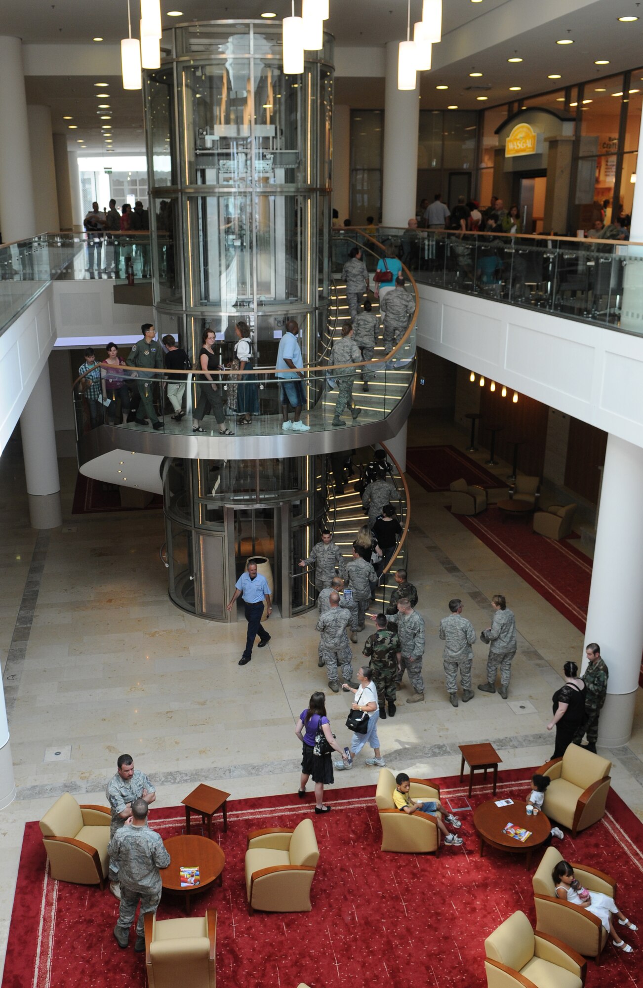 Members of the Kaiserslautern Military Community explore the new KMC Center after the ribbon cutting, Ramstein Air Base, Germany, July 2, 2009. Ramstein Inn’s Visitor's Quarters, Outdoor Recreation, Romano’s Macaroni Grill, a shoppette, Ramstein Tickets and Tours, the Sports Lounge and a German bakery are part of the first phase of openings at the KMCC. (U.S. Air Force Airman 1st Class Caleb Pierce)