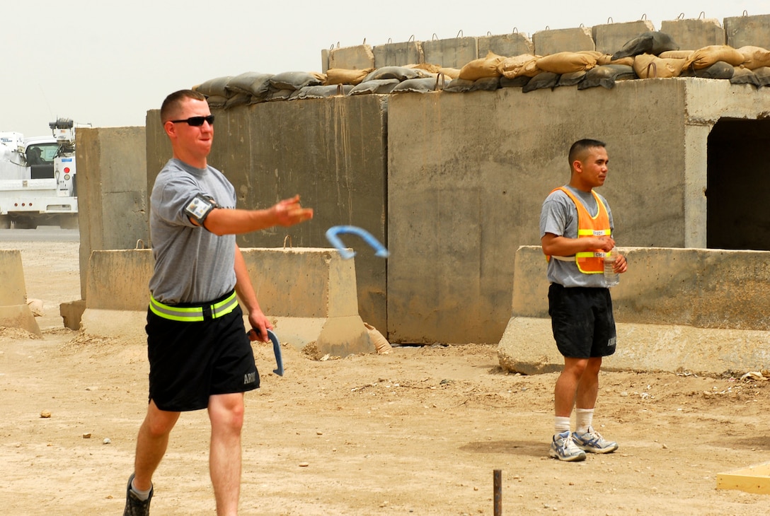 U.S. Army Spc. Robert McGrath supports his company in a game of horseshoes during the Fourth of July celebration on Forward Operating Base Delta, Iraq, July 4, 2009.The winners of the game were: Renegades in first place; Stash in second; and Non-stop Monster Truck Action in third,
