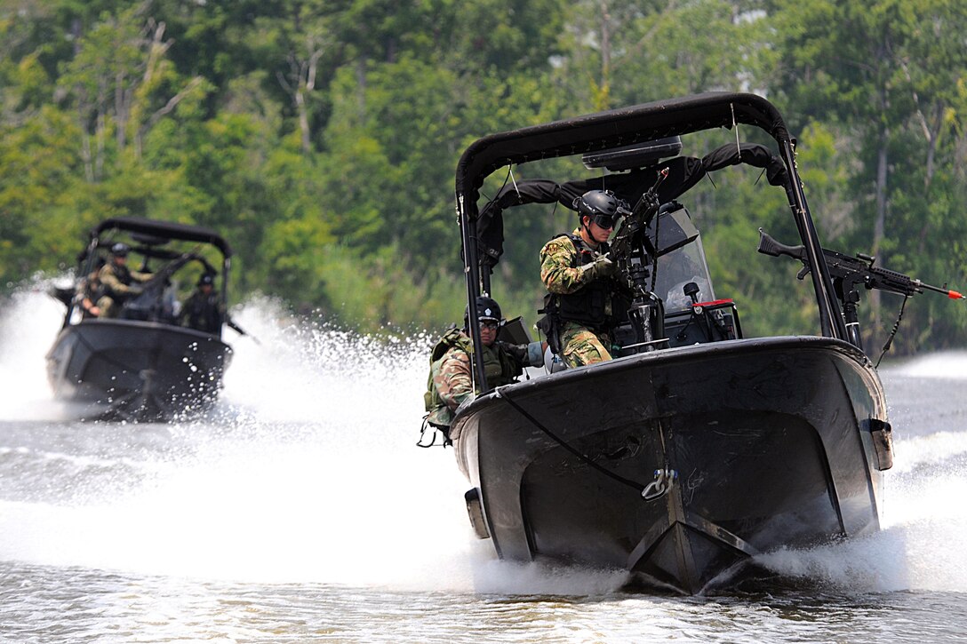 Students from the patrol craft officer course at the Naval Small Craft Instruction and Technical Training School extract students from the Western Hemisphere Institute for Security Cooperation during a field training exercise at the Stennis Space Center in Hancock County, Miss., June 29, 2009. The school's mission is to provide partner nation security forces with the highest level of riverine and littoral craft operations and maintenance technical training; the institute focuses on providing professional education and training.