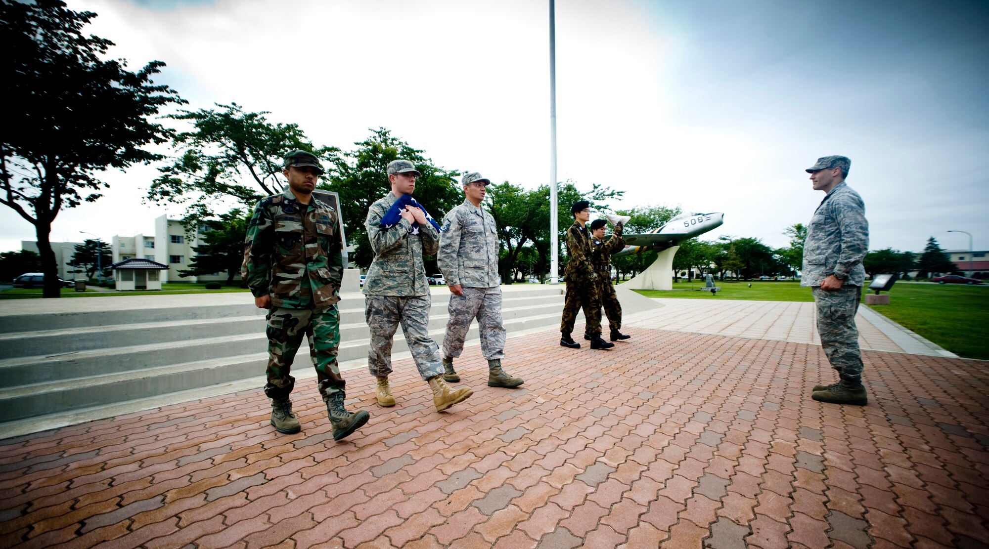 MISAWA AIR BASE, Japan -- Members of the 35th Fighter Wing staff agencies and Japan Air Self-Defense Force prepare to retire the colors during a retreat ceremony July 2 at the base flag pole. The ceremony was held in honor of Independence Day but also served as a way to pay respects to the host nation, Japan. (U.S. Air Force photo/Senior Airman Jamal D. Sutter)
