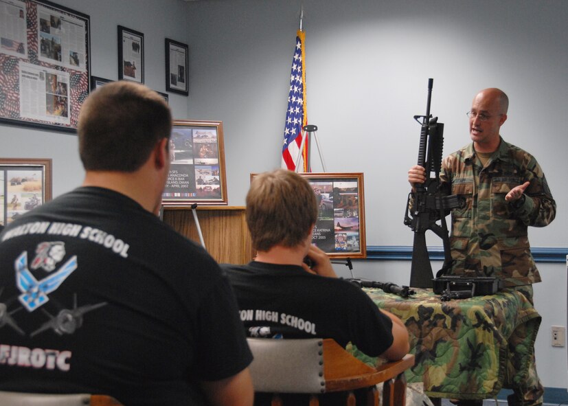 Air Force Reserve Master Sgt. Joe Stapp, 919th Security Forces Squadron, briefs Walton High School Junior ROTC cadets on weaponry and equipment June 30 as part of the 919th Special Operations Wing’s Junior ROTC Day at Duke Field.  Four other high school Junior ROTC programs also visited, getting tours of the life support shop, maintenance and even a short flight on an MC-130E aircraft.  Approximately 110 cadets and their leaders toured the base.  (U.S. Air Force photo/ Staff Sgt. Samuel King Jr.)