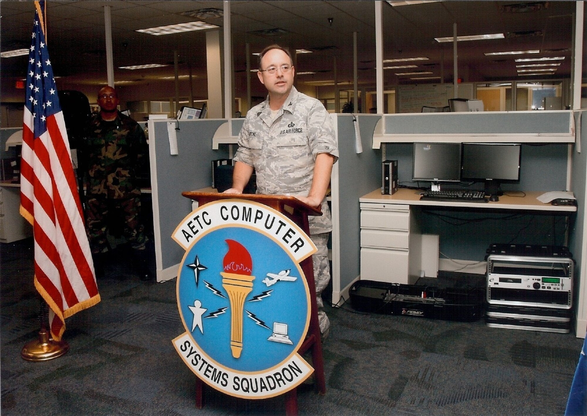 Col. Curt Locke, Air Education and Training Command Communications deputy director, addresses attendees at the ribbon cutting ceremony held May 22 dedicating a new facility for the Computer Systems Squadron Consolidated Telephone Operator's call center at Port San Antonio. The squadron moved to the facility in March with upgraded equipment designed to provide telephone service for all AETC bases.