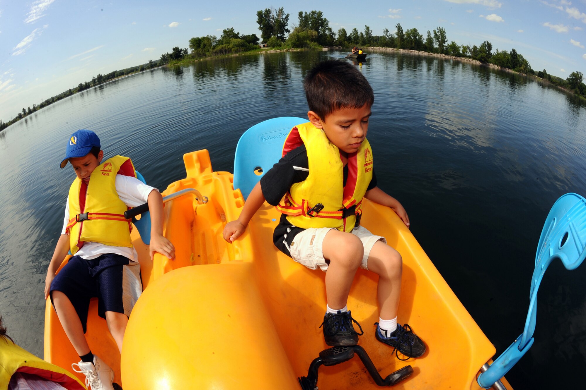OFFUTT AIR FORCE BASE Neb. -- Benaiah (left) and Joel Fern(right), sons of retired Major James Fern U.S. Strategic Command, skim across the base lake in a peddle boat during the Independence Day celebration at the base lake July 2. The annual celebration, included games, refreshments and a fireworks display at dusk.

U.S. Air Force Photo by Josh Plueger