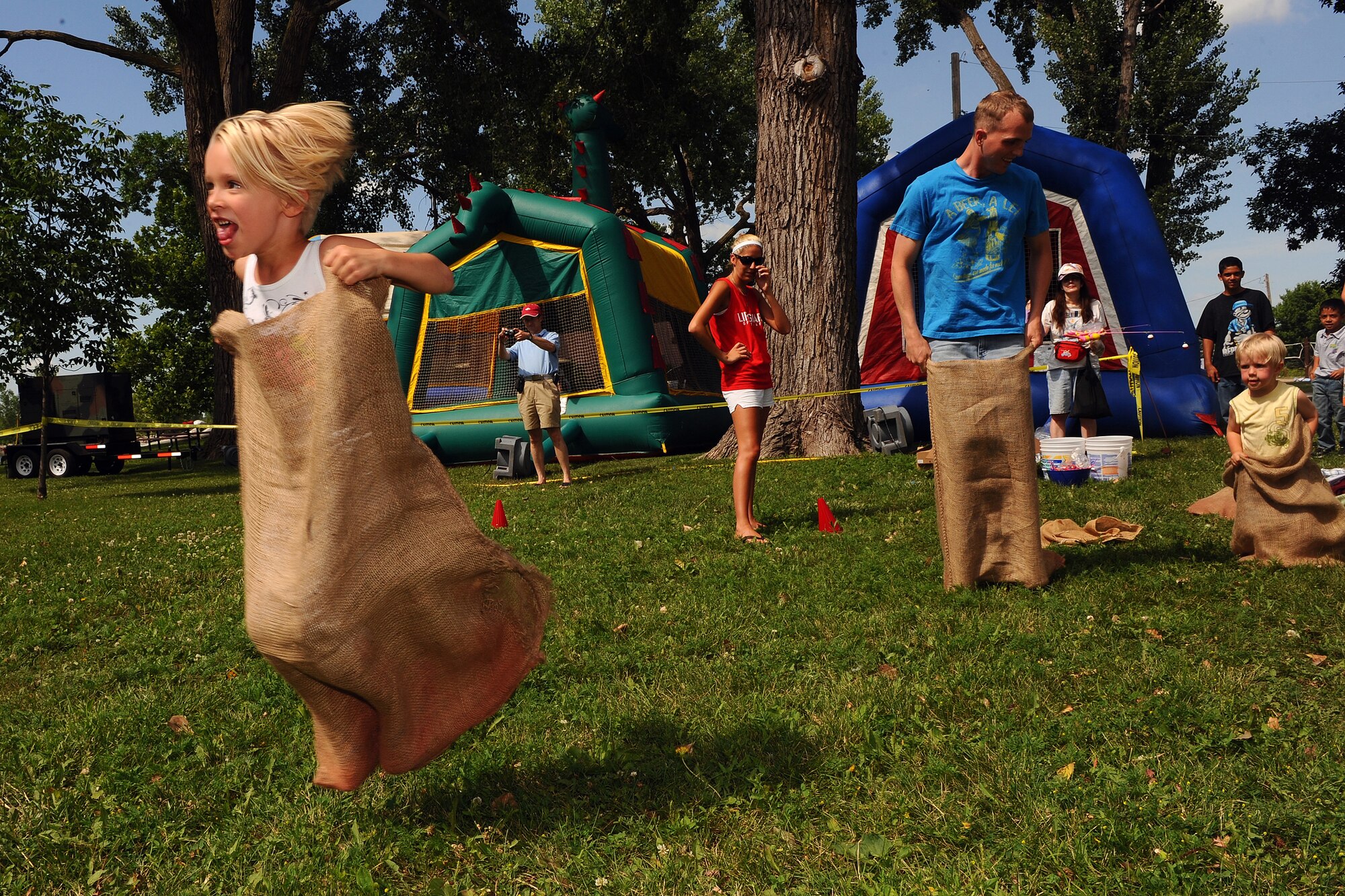 OFFUTT AIR FORCE BASE Neb. -- Genavieve, 5, daughter of Airman 1st Class Evan Cater, 55th Medical Group, takes off in a sack race during the Independence Day celebration, at the base lake July 2. The annual celebration, included games, refreshments and a fireworks display at dusk.

U.S. Air Force Photo by Josh Plueger