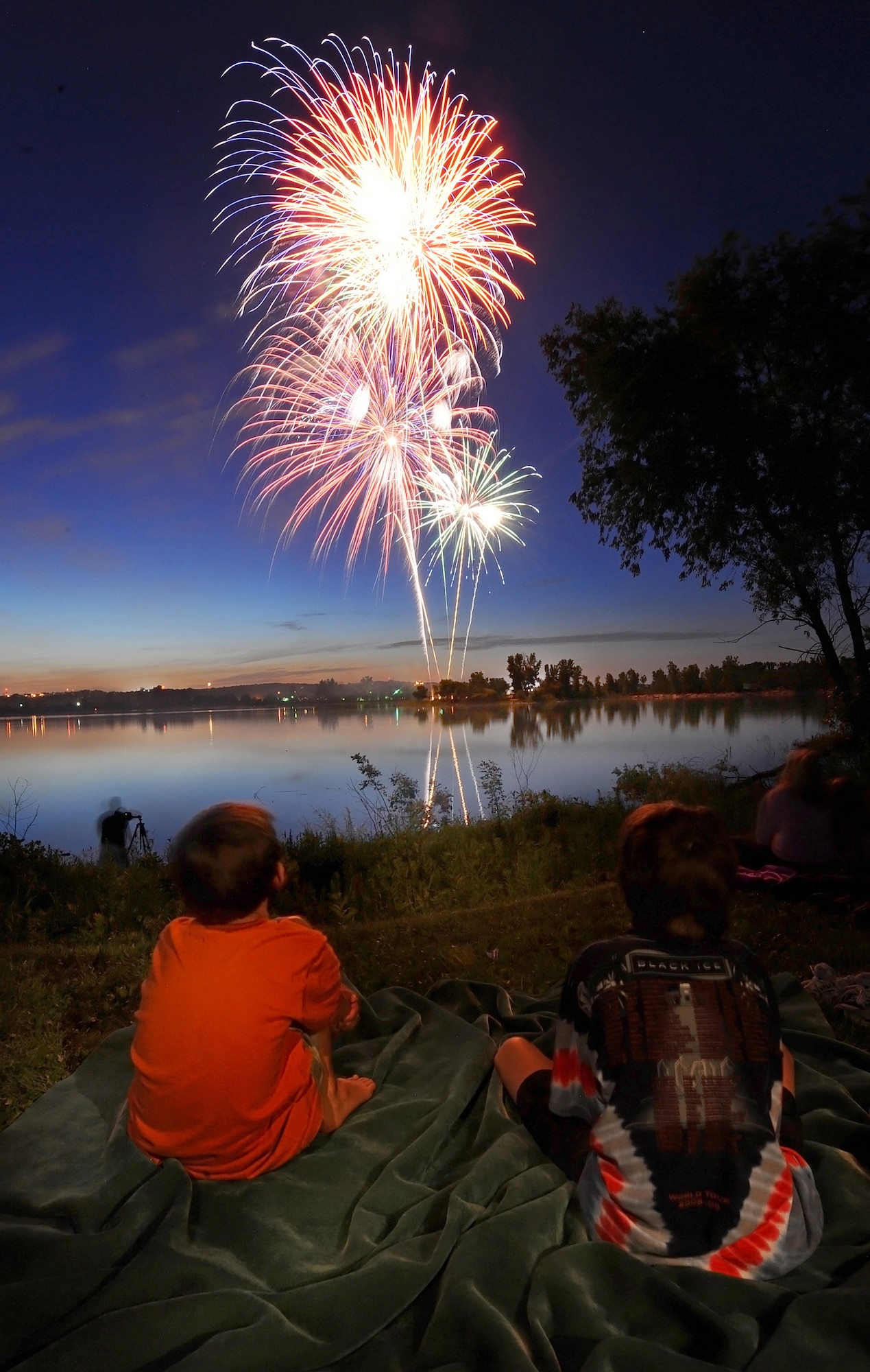 OFFUTT AIR FORCE BASE Neb. -- Two children watch the night skies over the base lake explode with colors as they attended the Independence Day celebration July 2. The annual celebration, included games, refreshments and a fireworks display at dusk.U.S. Air Force Photo by Josh Plueger