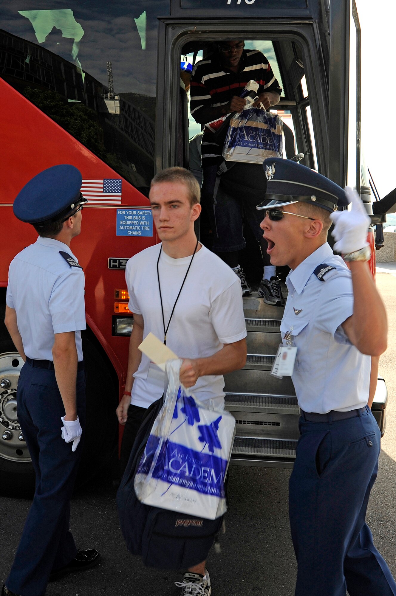Cadet cadre shout, "Get off my bus!" at basic cadets as they exit near the Core Values Ramp for cadet inprocessing June 25 at the U.S. Air Force Academy in Colorado Springs, Colo. (U.S. Air Force photo/Mike Kaplan) 