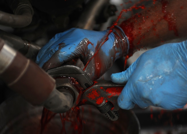 Corey Seeber disconnects the hydraulic lines from the hydraulic pumps on a C-17 engine here June 22. The pumps and lines are disconnected so that inspectors can check each piece separately. The all-civilian engine shop installs, inspects and repairs five to six engines a month. Mr. Seeber is an aviation maintenance technician with United Airlines. (U.S. Air Force photo/Senior Airman Katie Gieratz)(Released)
