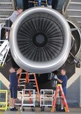 Aviation maintenance technicians work on a C-17 engine at the engine test cell building here June 18. The all-civilian engine shop installs, inspects and repairs five to six engines a month. (U.S. Air Force photo/Senior Airman Katie Gieratz)
